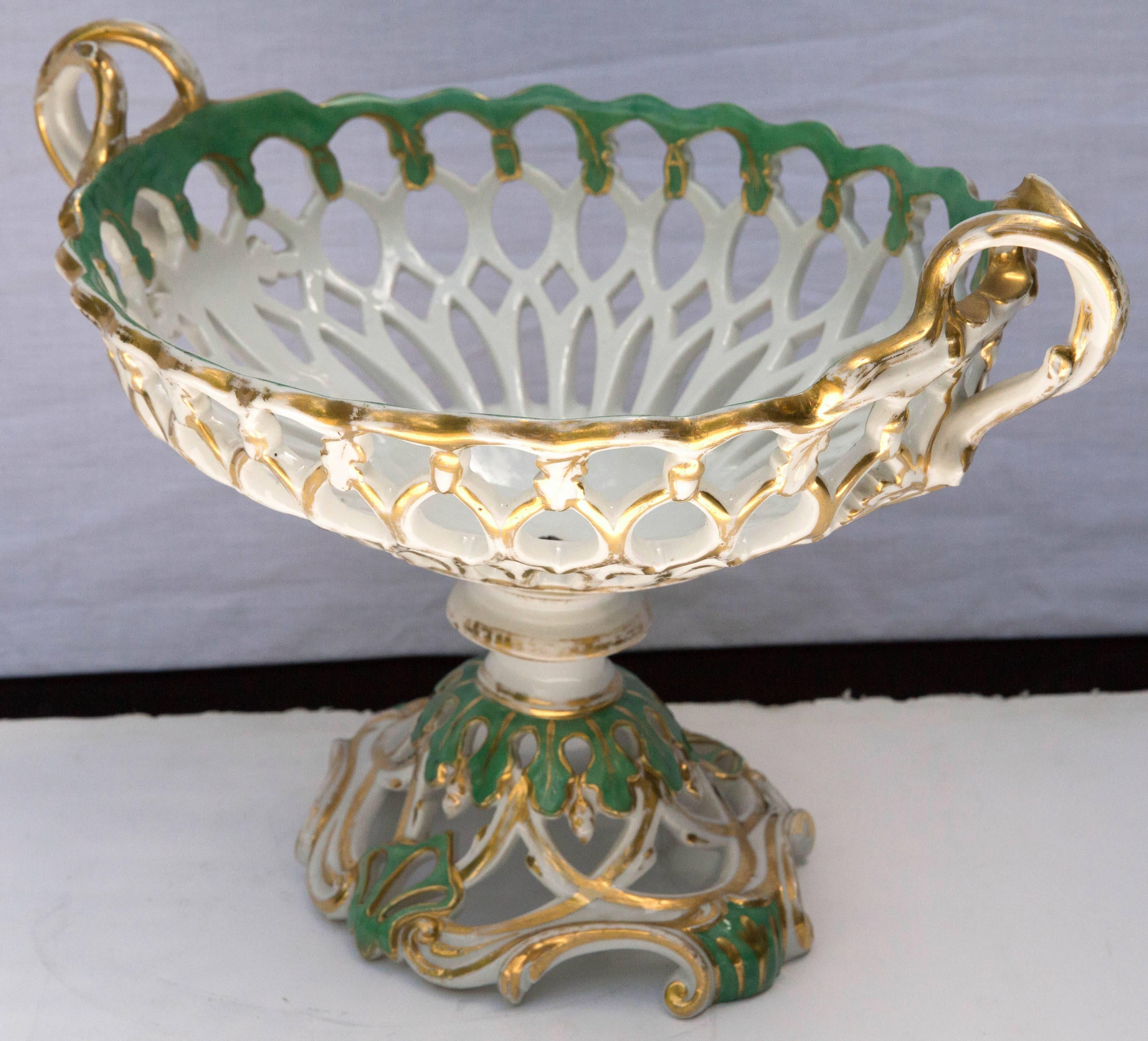 A lovely green, gilt and white glazed porcelain compote in a decorative footed basket form.