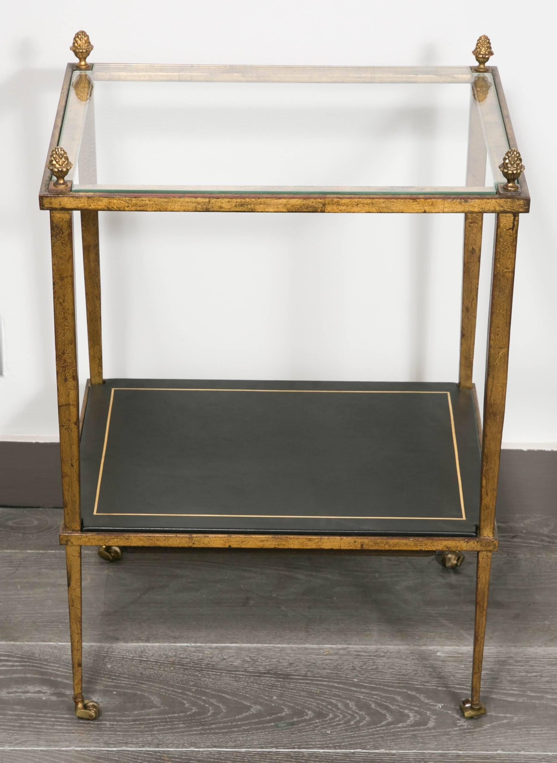 Elegant and rare pair of side tables in gold wrought iron with beautiful and vintage patina.
Glass top and new black leather.
Please note the secret drawer in wood.
By Maison Ramsay,
circa 1960.
