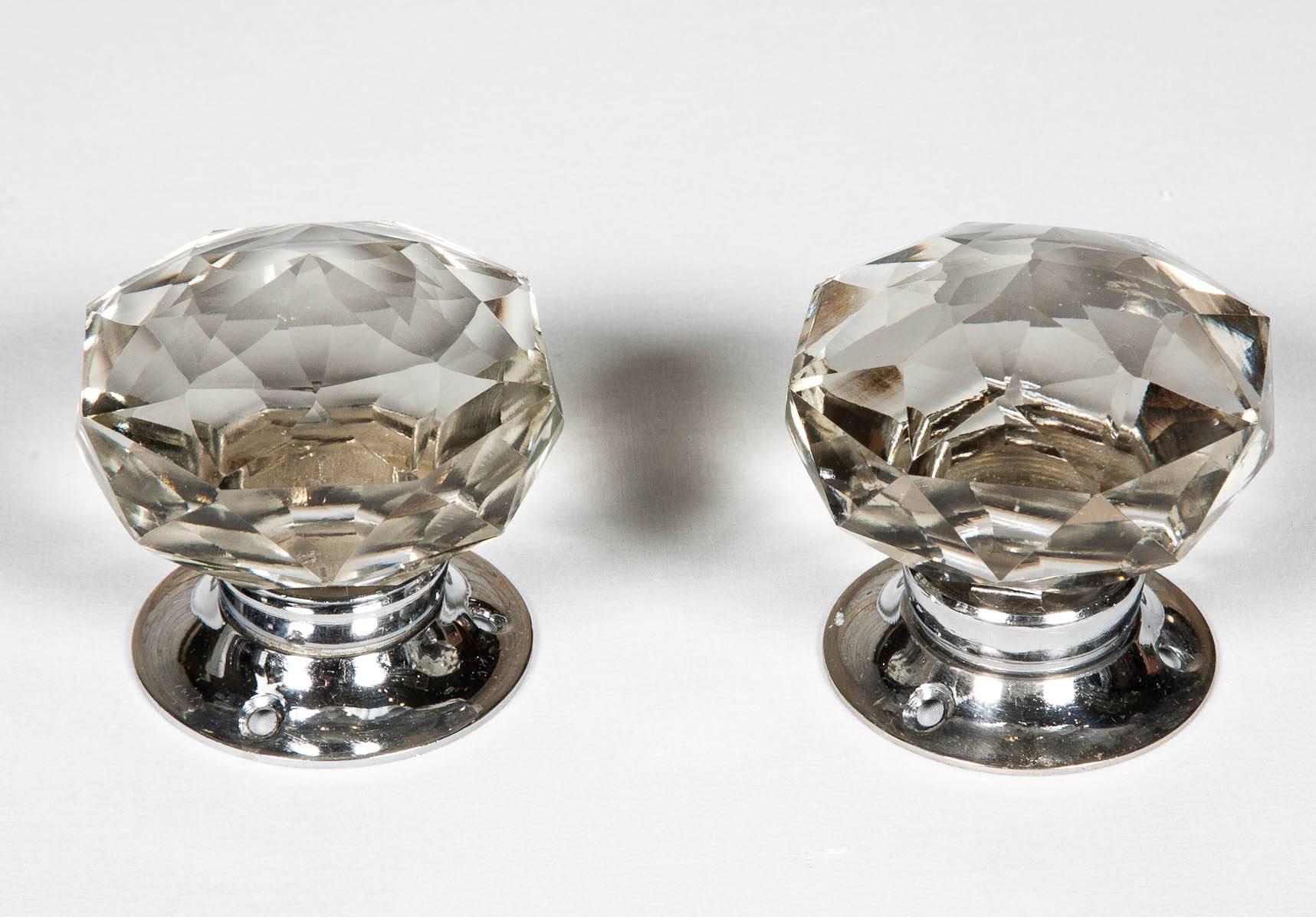 A set of stunning faceted glass door knobs with a chrome plate. These reclaimed door knobs have an attractive design and reflect and refract light beautifully.
 