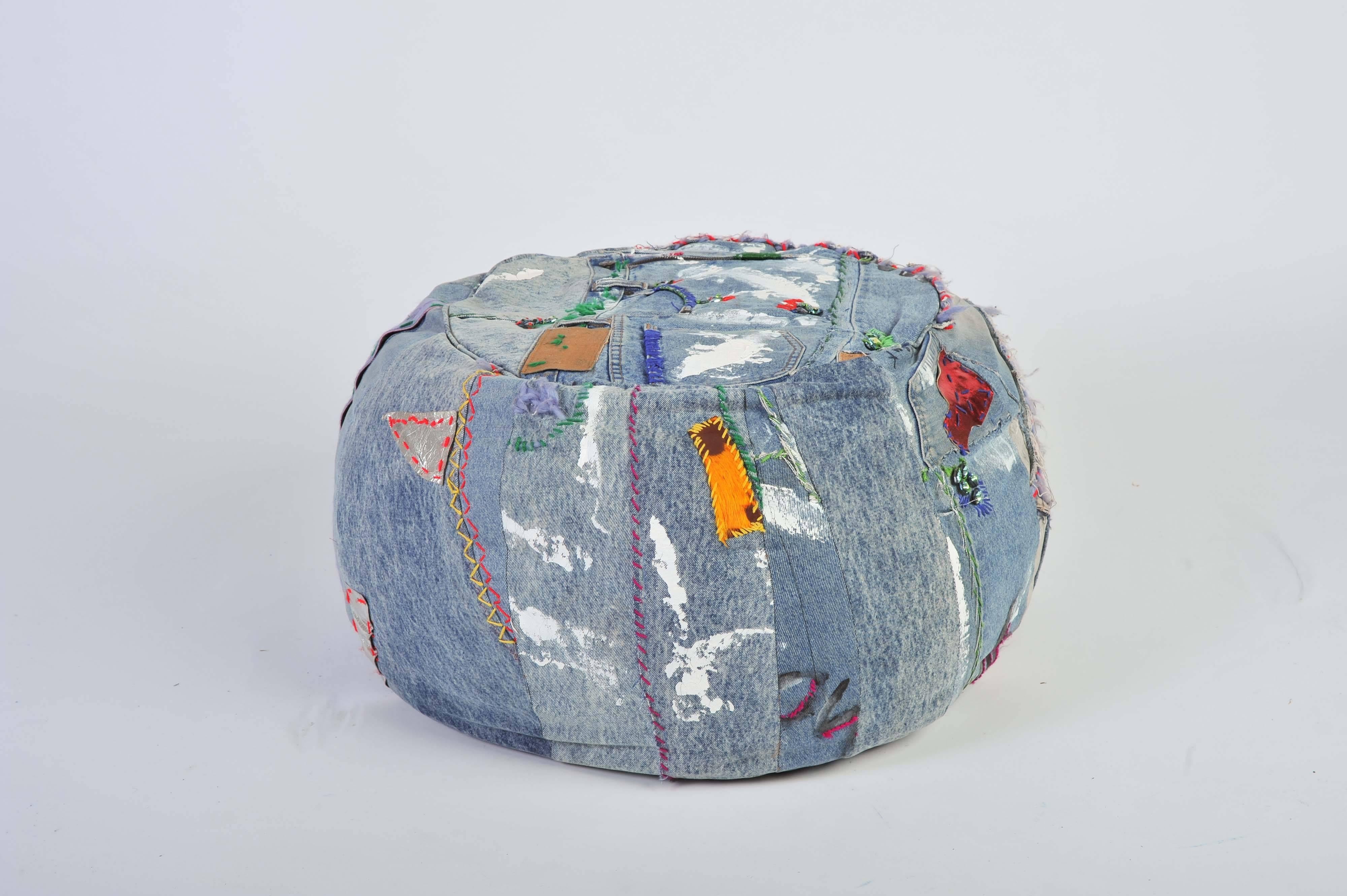 A unique handmade Bohemian Rock and Roll style ottoman/pouffe/floor cushion. Made out of 1970s vintage jeans denim, leather, paint, crystals and hand embroidery.

Made by Joelle Talmasse.