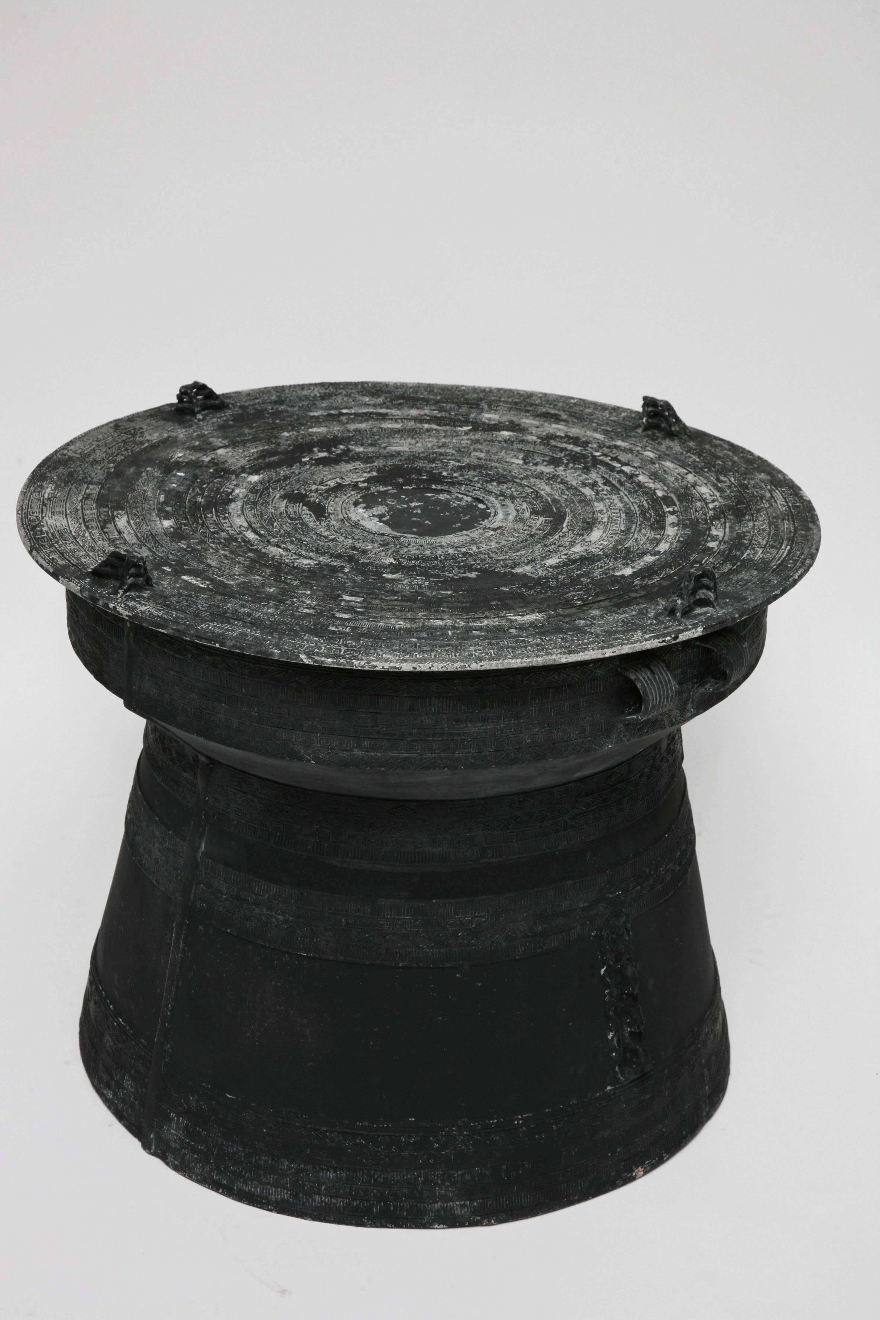 Modeled after traditional bronze rain drums from Thailand, this thoroughly engaging black-painted, cast aluminum version is made all the more interesting by its naturally distressed finish. We love it just as it is (and would probably bring it out