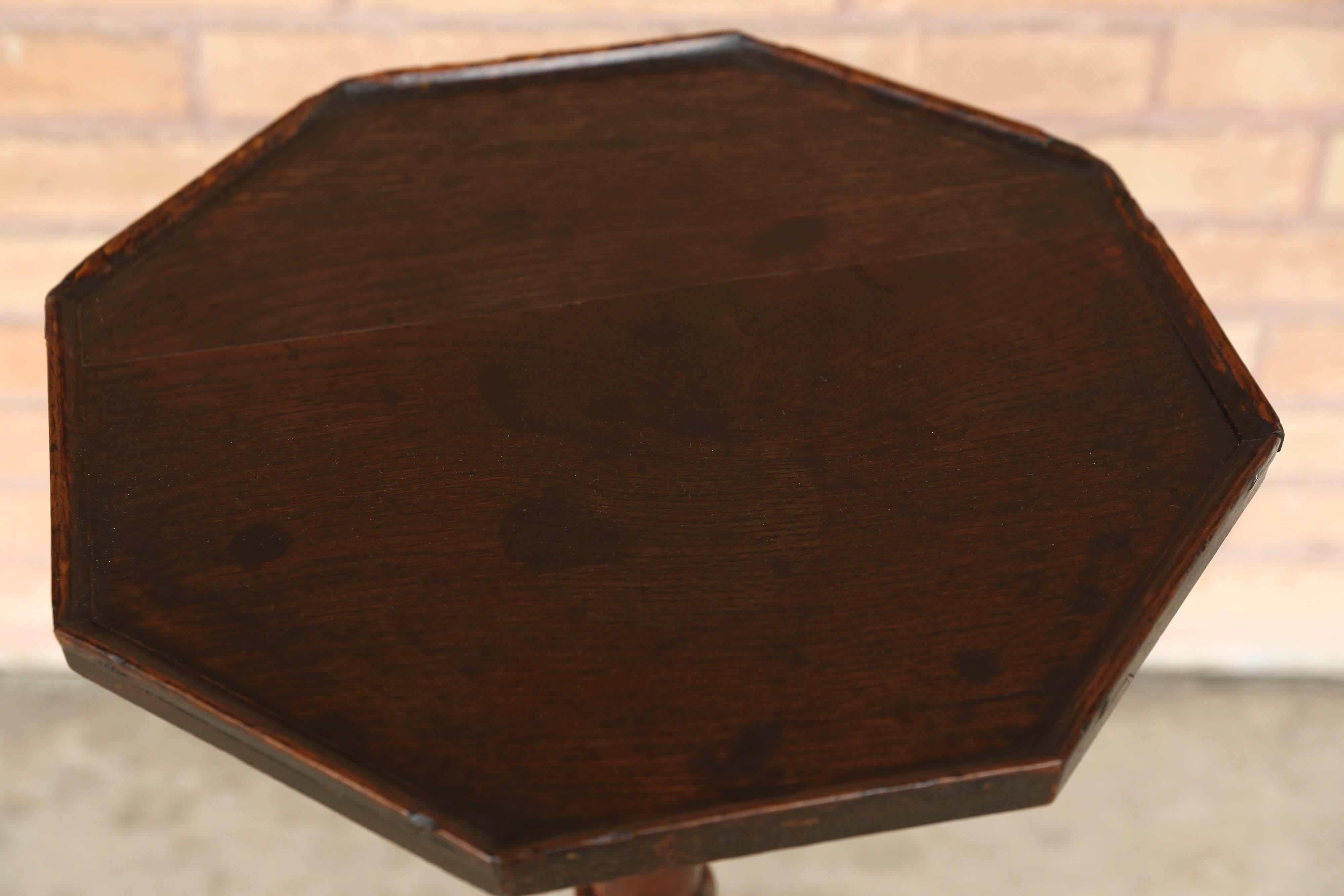 Antique 19th century English octagonal oak wine table on tripod base.