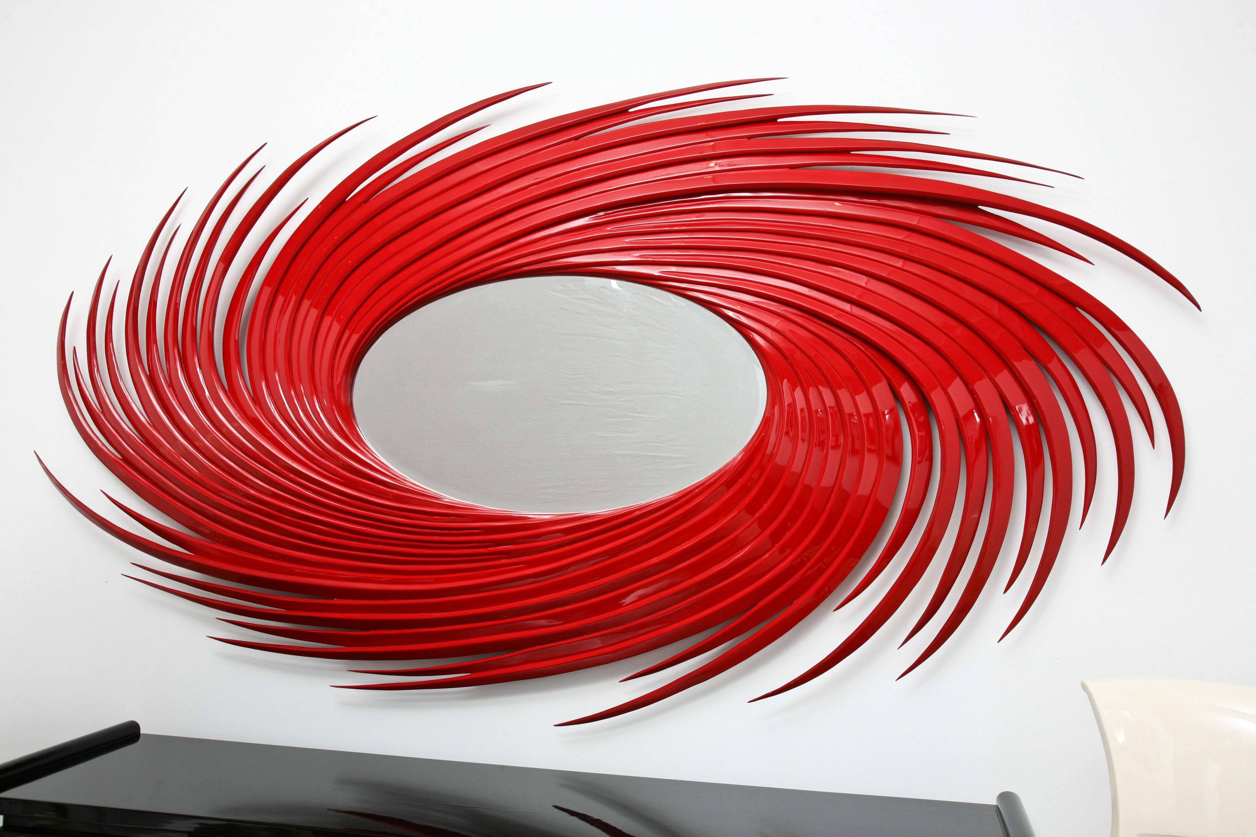 Red lacquer mirror by Christopher Guy inspired by the motion and depiction of a hurricane. The mirror is gigantic in scale - a real statement piece.