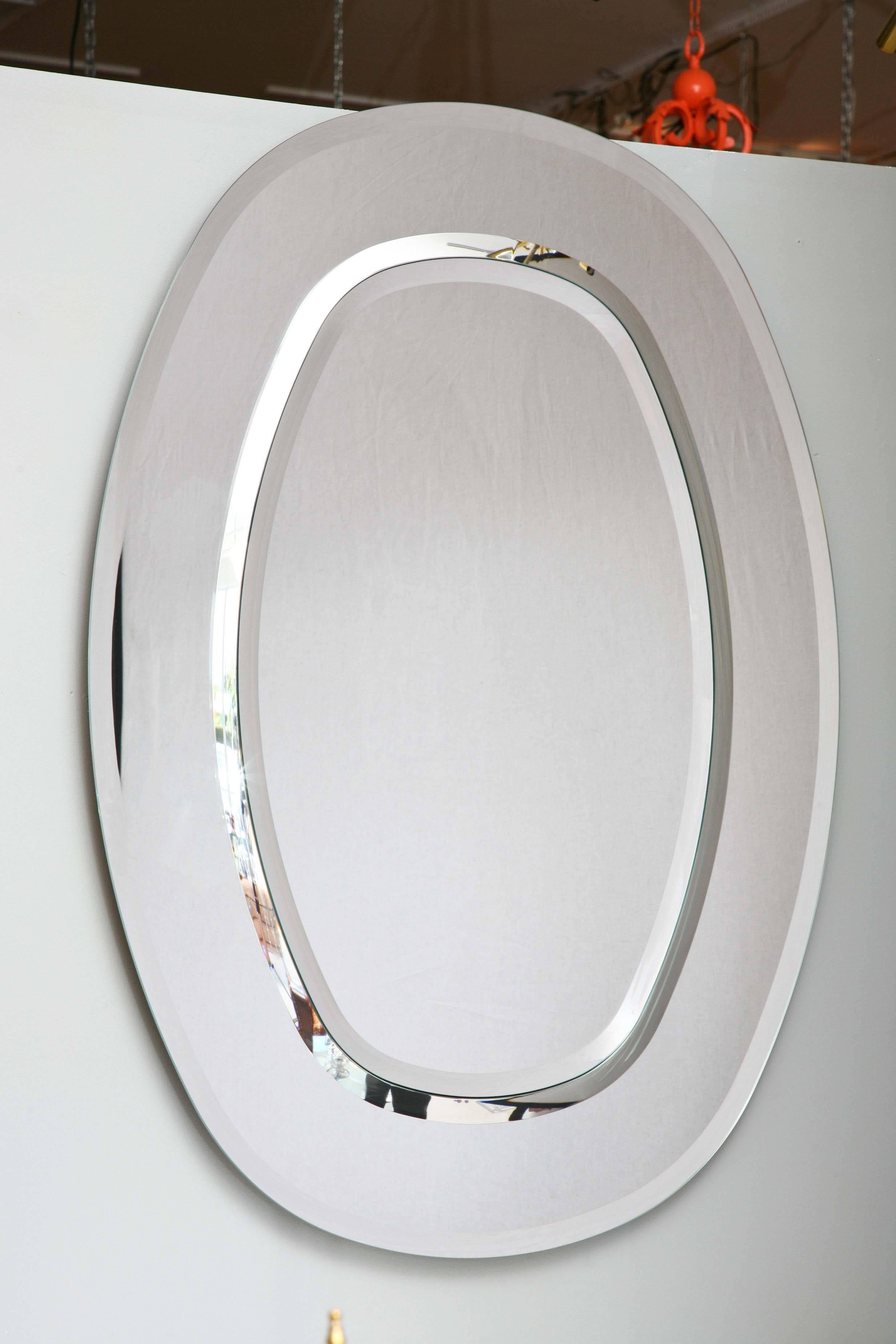 Colorless oval mirror made in Italy with simple profile and soft bevel to edge.

Two Available 