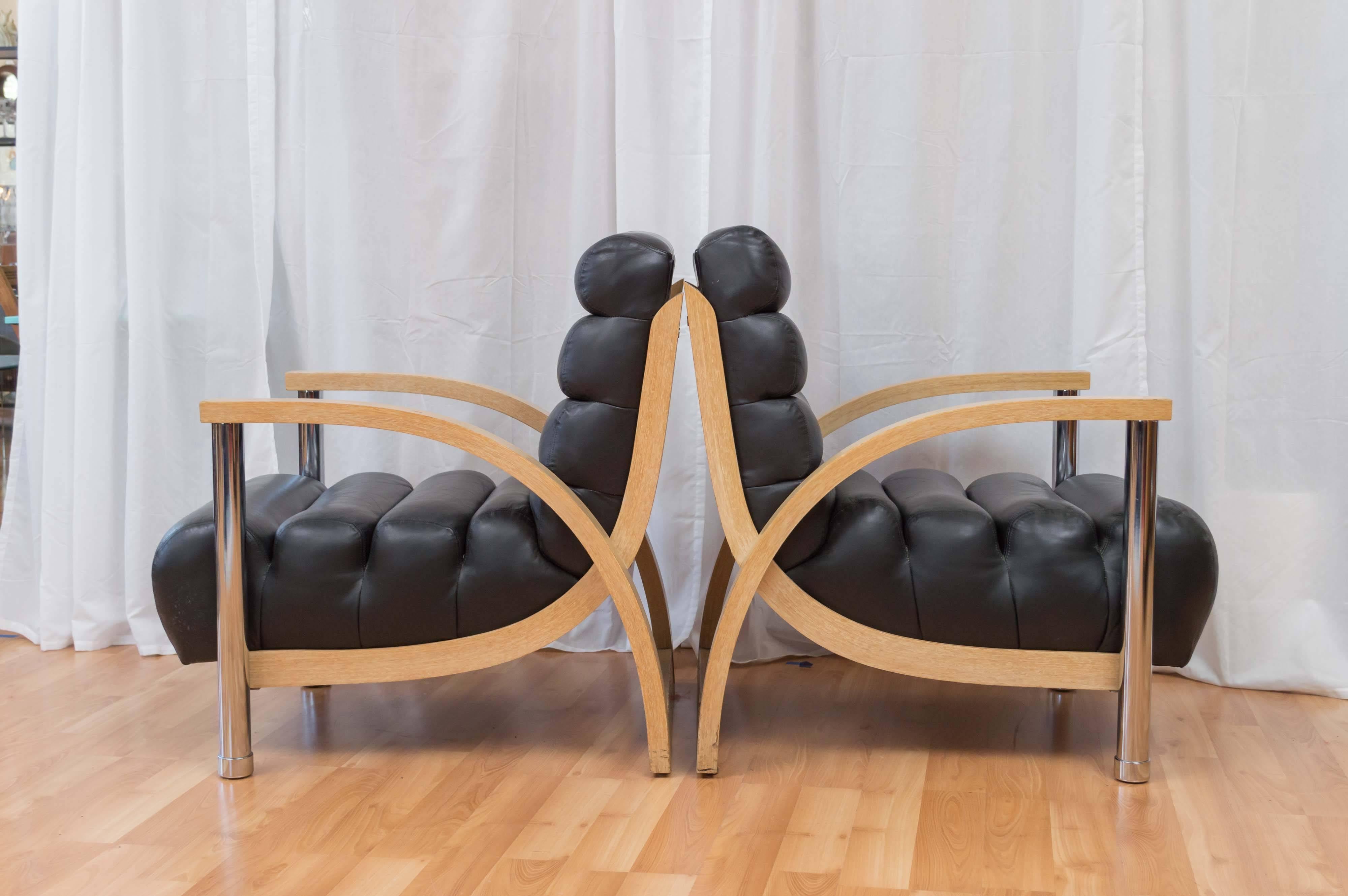 A pair of oversized Art Deco-meets-Memphis-style oak, leather, and chrome “Eclipse” club chairs by New York-based designer Jay Spectre for Century.

Thick bentwood frame features cerused oak veneer with semi-opaque cream varnish wash, and