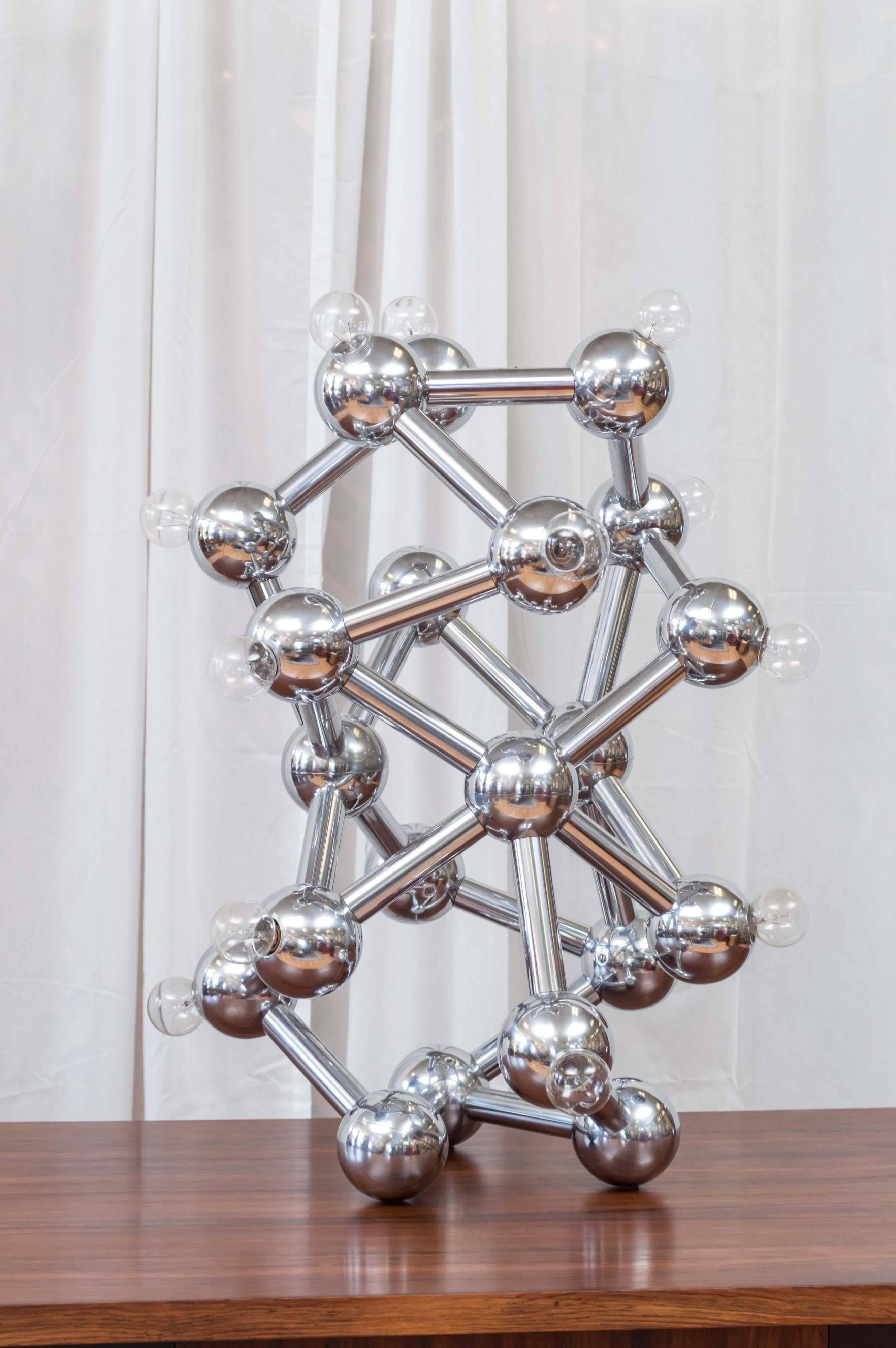 An awesome and oversized eighteen-light chrome “molecule” table or floor lamp by Torino.

The design—with its chrome tubes, joints, and spheres—is very reminiscent of the iconic Atomium constructed for the 1958 World’s Fair in Brussels. Large enough