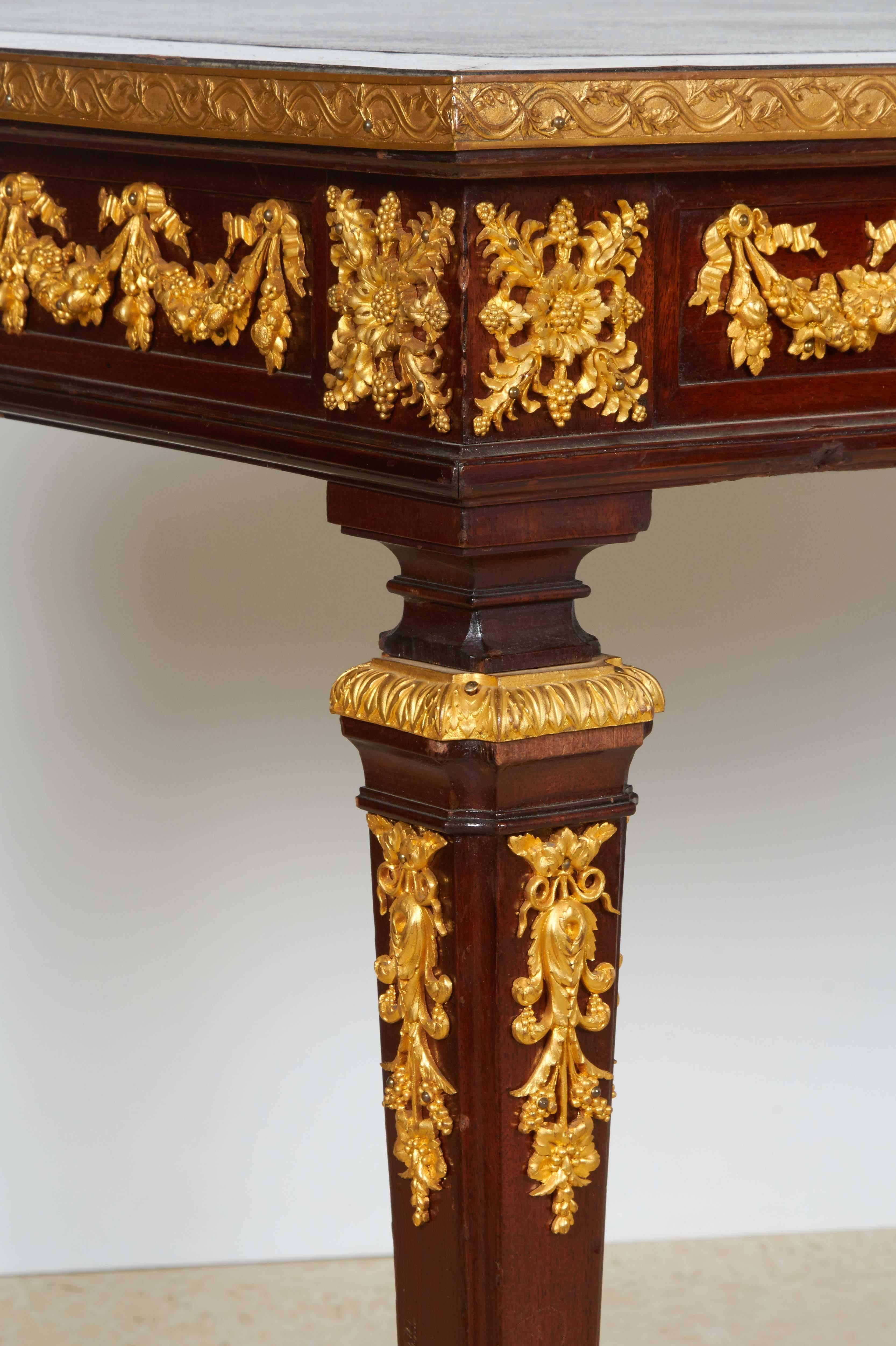 A French ormolu and jasperware Wedgewood-mounted mahogany center table desk. 

With inset leather writing surface. Porcelain Wedgewood plaque to each side, on tapering legs joined by a loop stretcher.

Unsigned but possibly by Henry Dasson.

