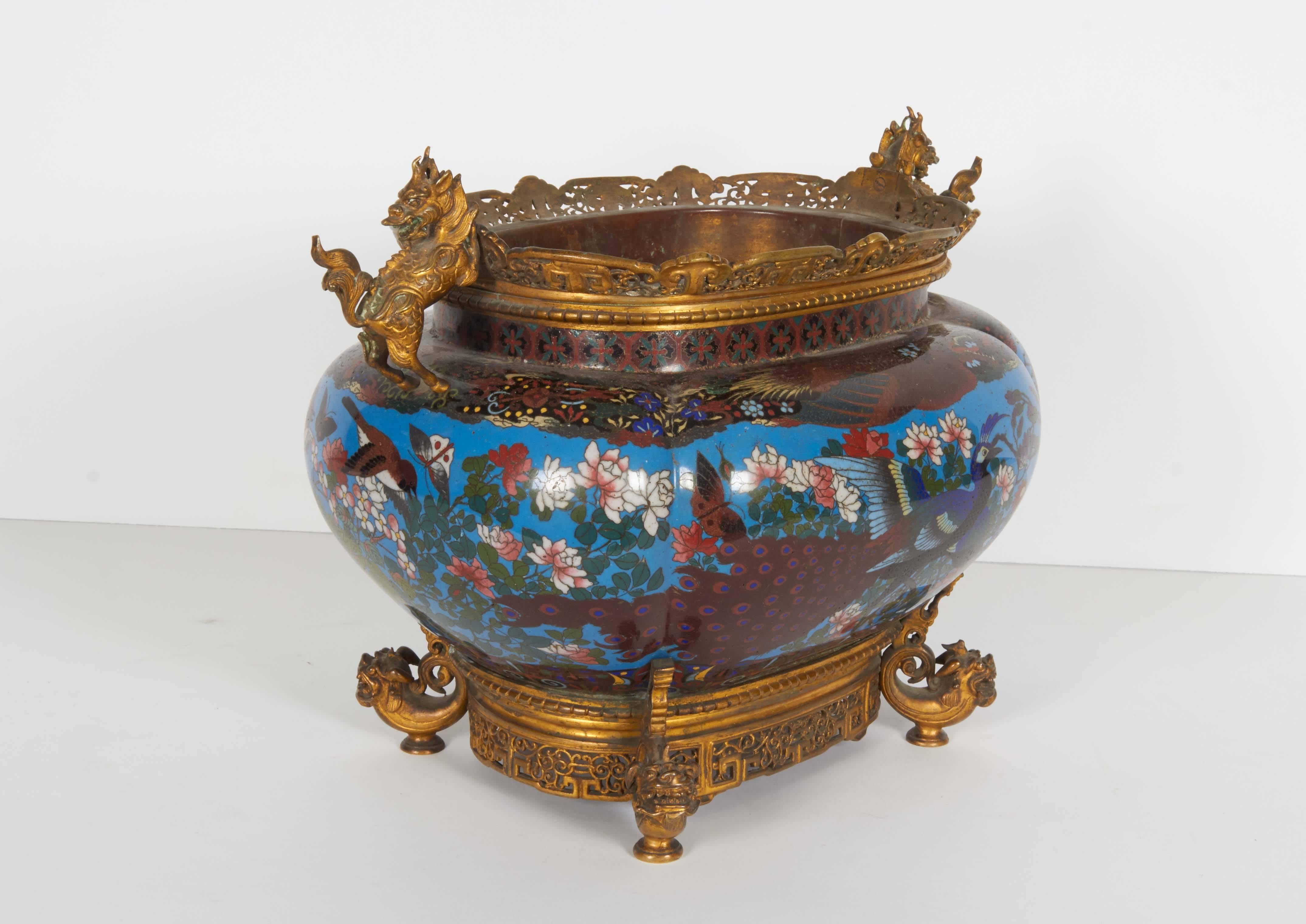 A French Japonisme ormolu-mounted three-piece Japanese cloisonné enamel garniture.

The bronze mounts are attributed to Ferdinand Barbedienne.

Comprising of a pair of vases and a centerpiece / jardiniere. 

Very finely painted.

Vases: 14