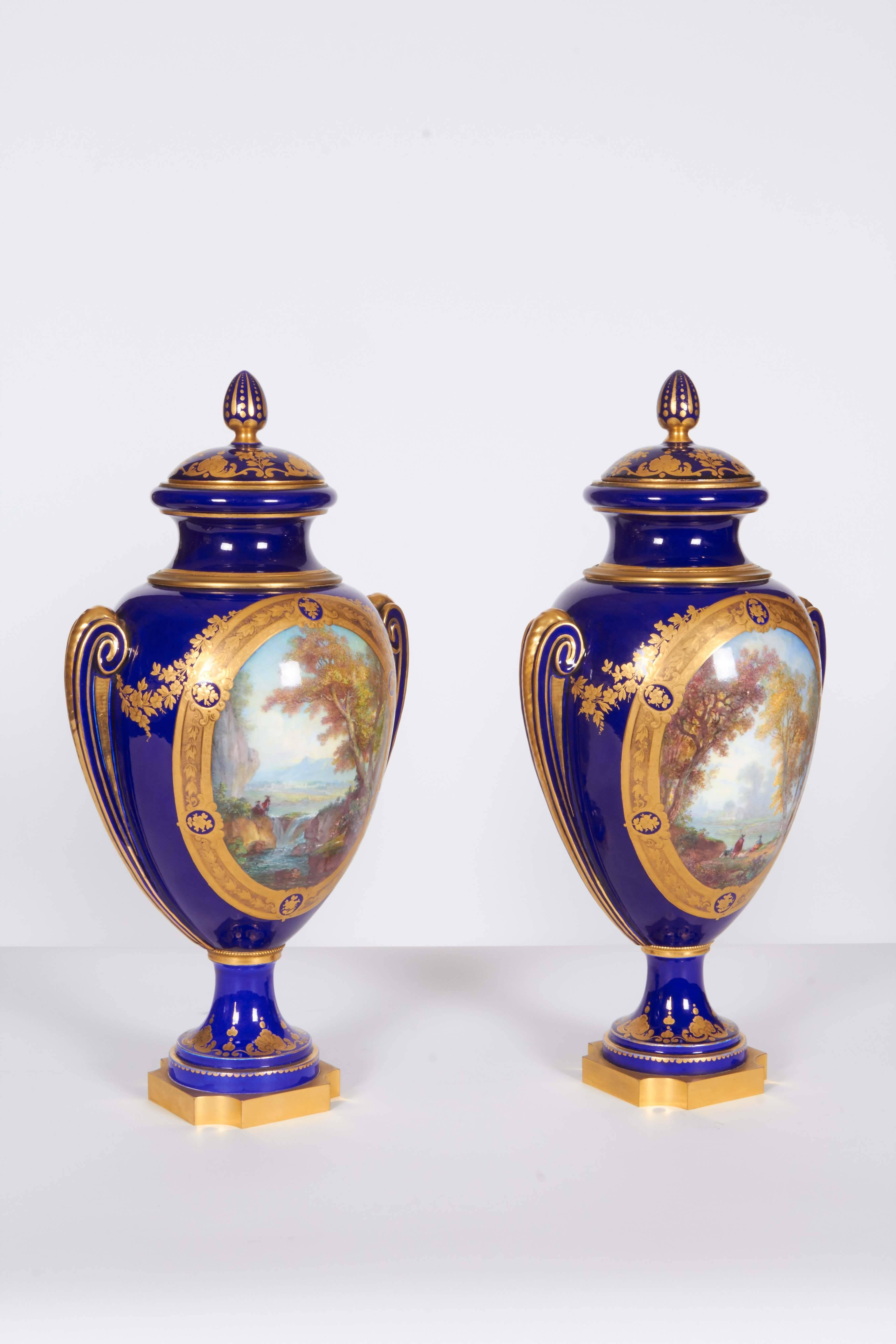 Pair of Napoleon III Sevres porcelain cobalt blue vases and covers on ormolu bases.

Vases 'DE PARIS'.
Dated 1863-1867, Crowned N DECORE A SEVRES 1867 MARKS, Incised A63, The ormolu bases are each stamped twice.

Very finely painted.

For a