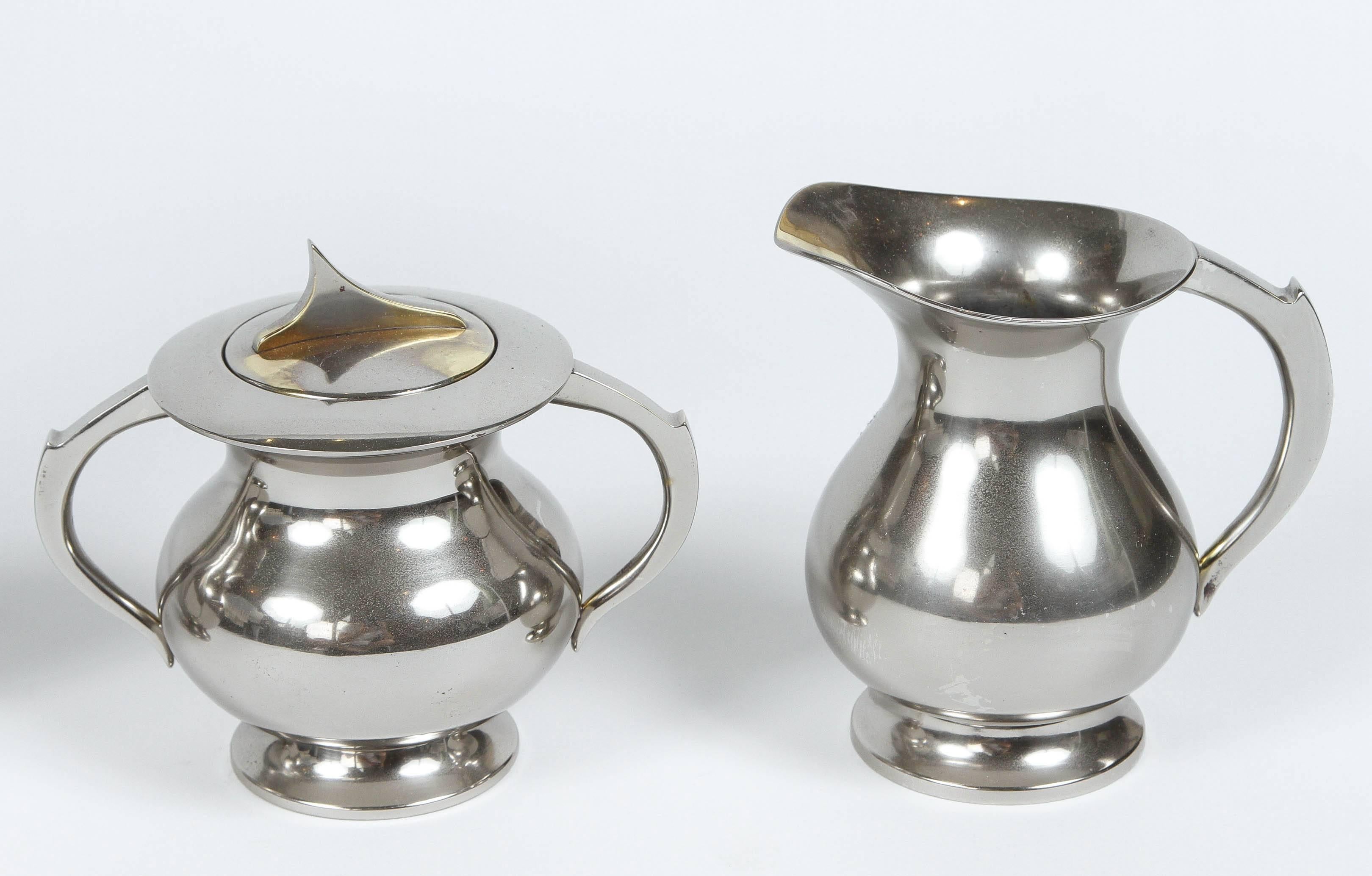 Mid-Century coffee set with coffee pot, tea pot, cream and sugar. Newly polished silver plate over brass. Bottom of coffee pot is stamped 
