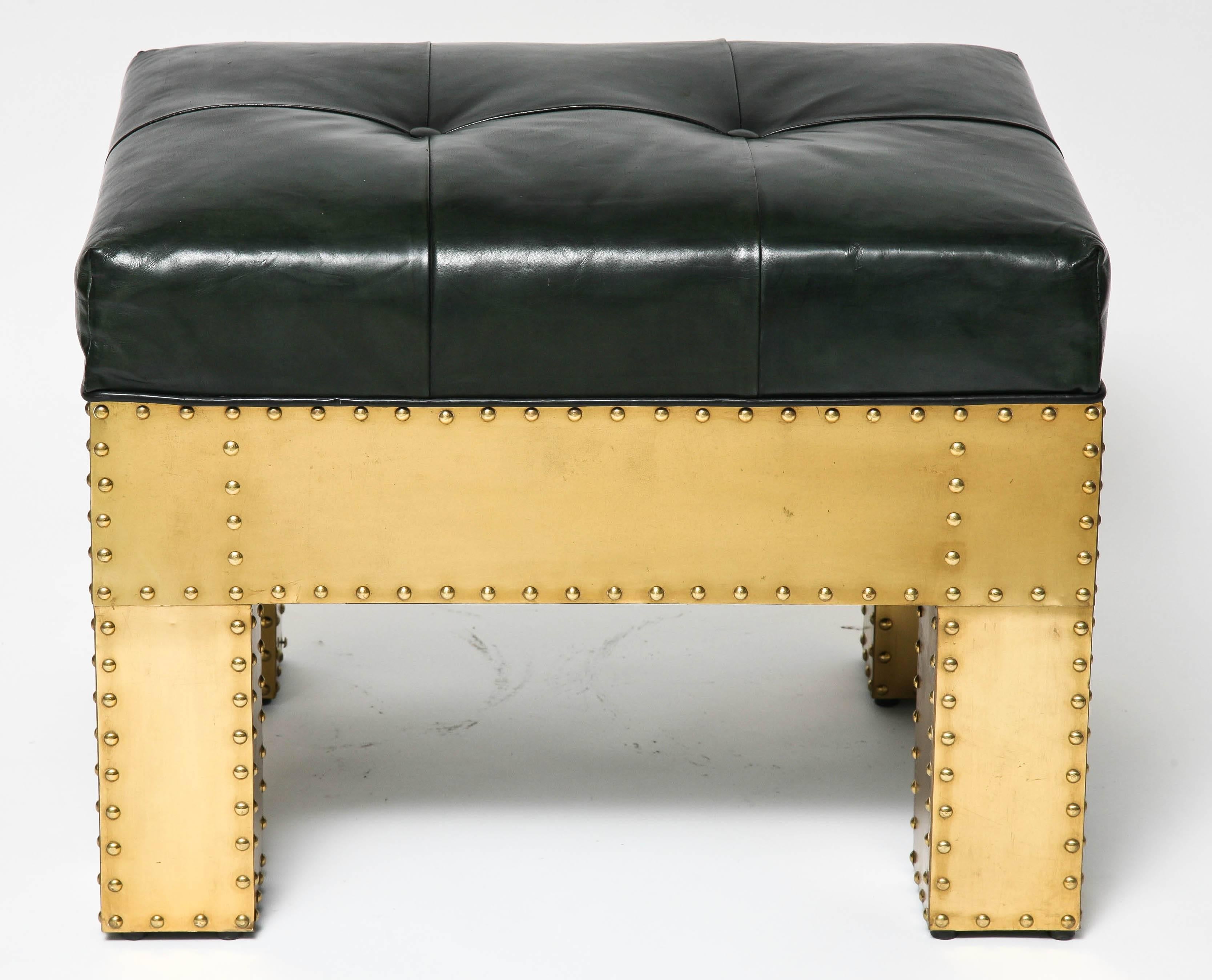 This handsome bench was created in the 1970s by the firm Sarreid Ltd. The frame in constructed of brass panels with brass studs and the upholstery is in a dark black leather with button-tufted detail.

For best net trade price or additional