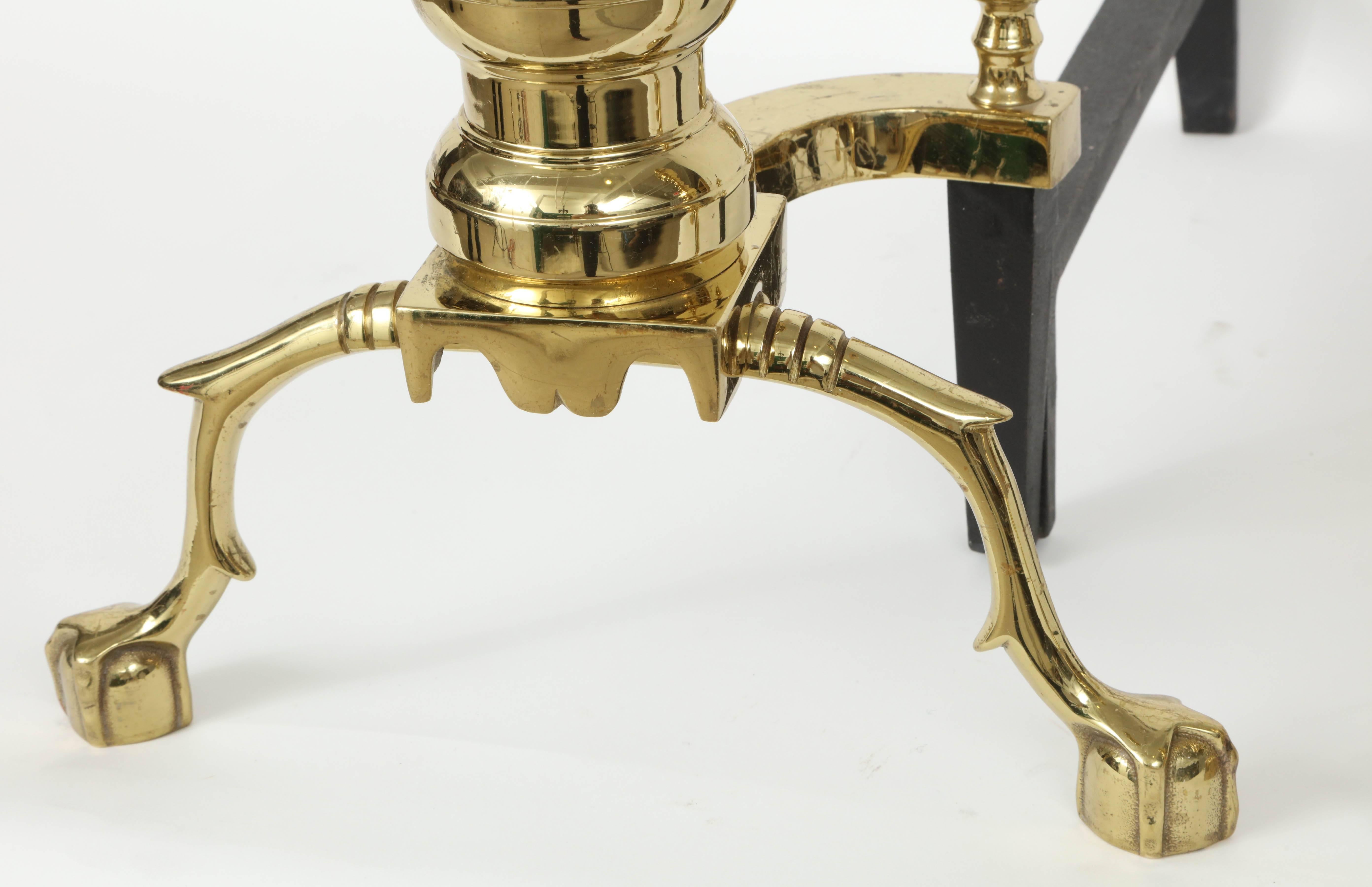 Pair of Hollywood Regency, large-scale brass andirons with ball/ claw feet.