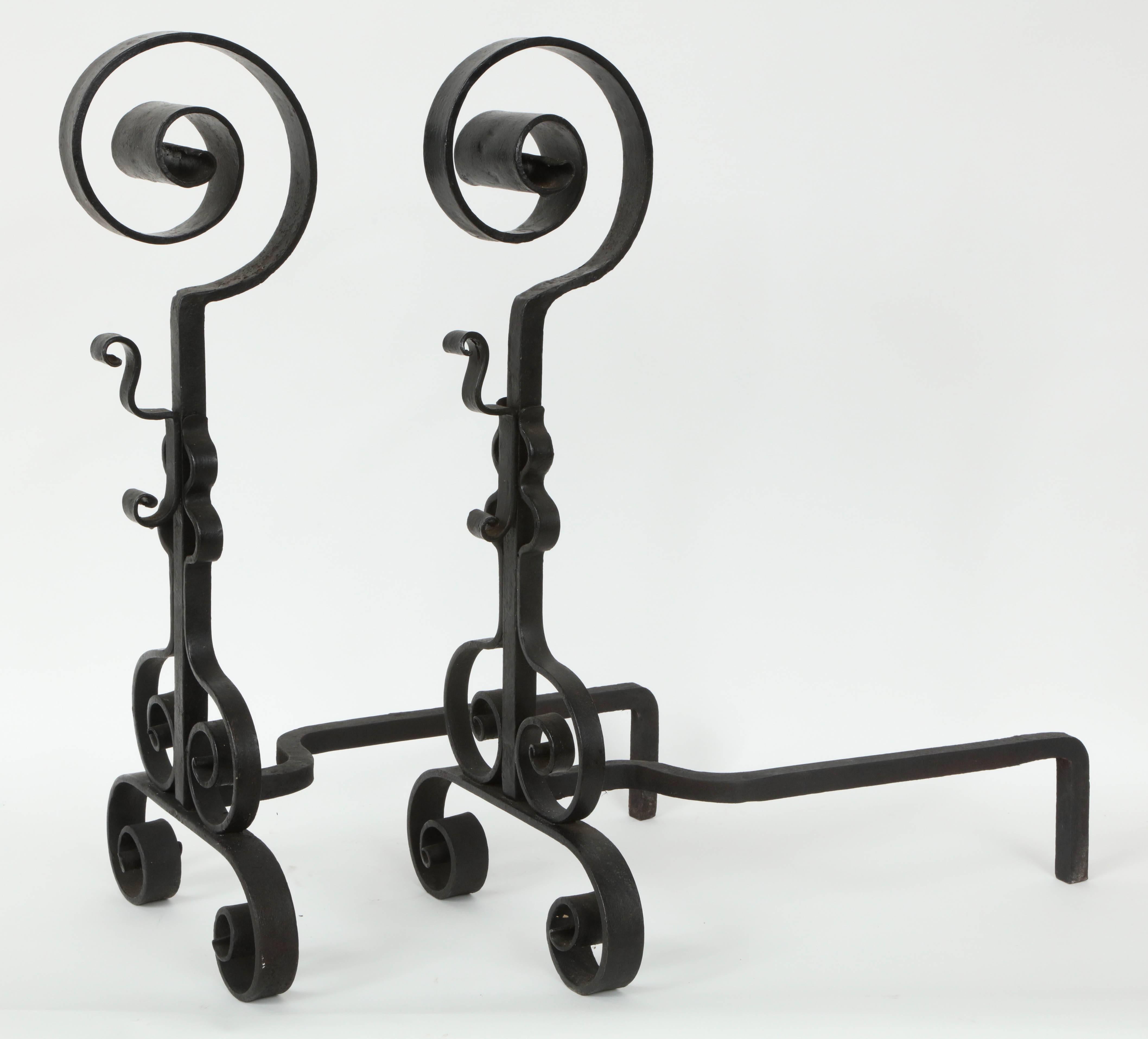 Fantastic pair of hand-forged blackened wrought iron andirons with curled metal details.