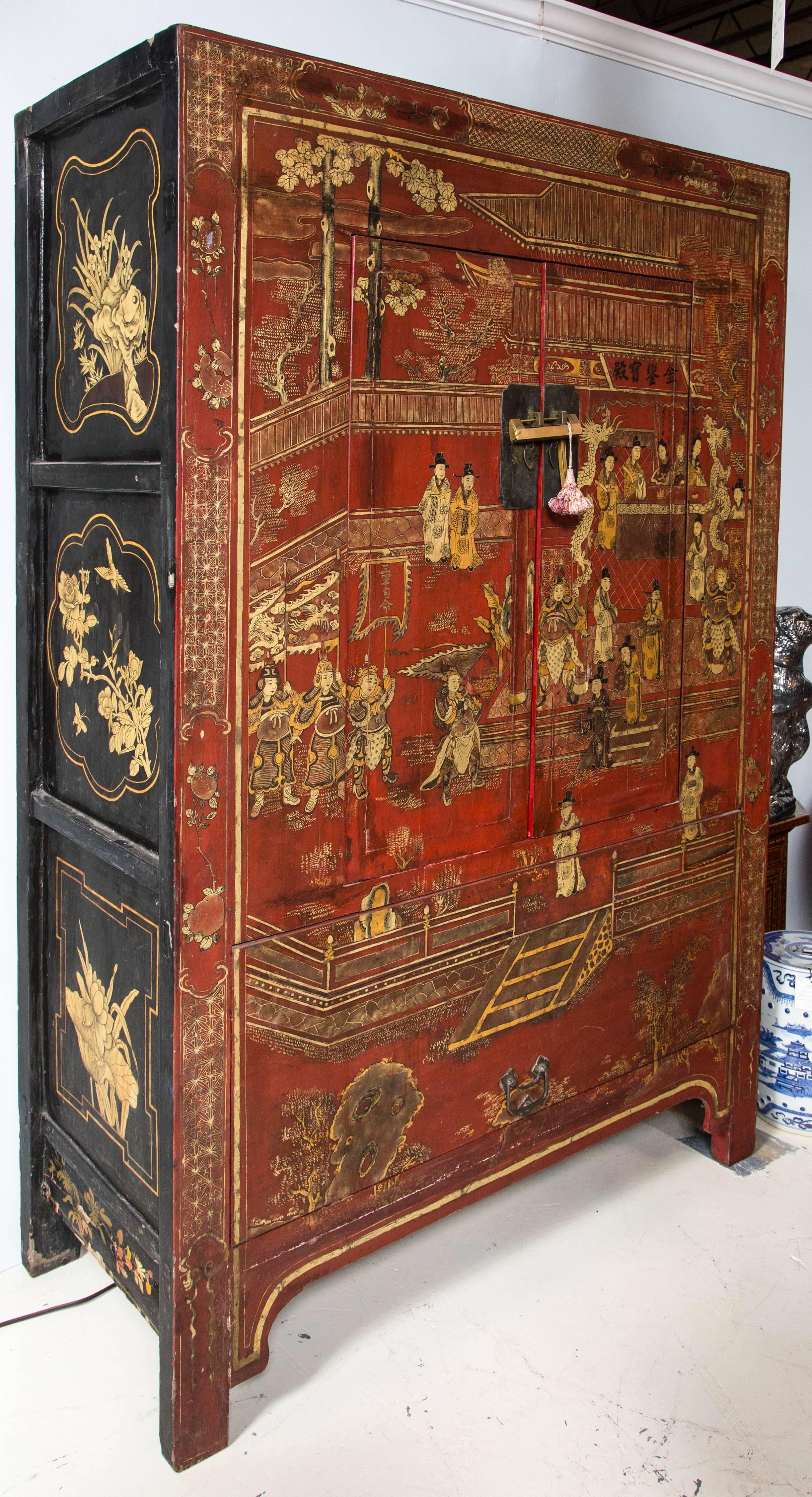 Vintage Chinese, red lacquer armoire/cabinet with painted scenes of court life. Hinged door in the base.