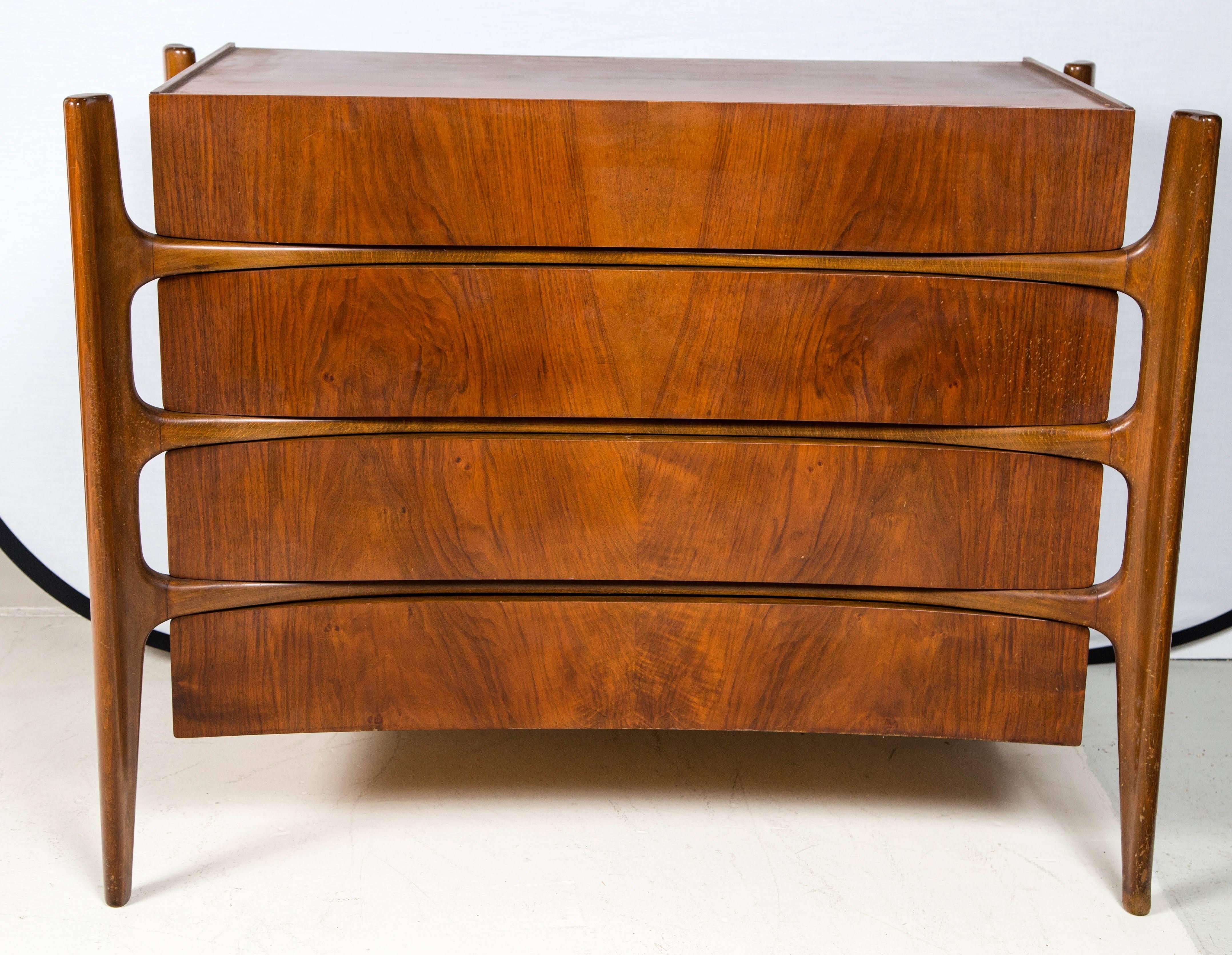 Chest of drawers with four conforming drawers. Concave with outside legs. 
William Hinn for Urban Furniture Company Chest of Drawers
Walnut.
