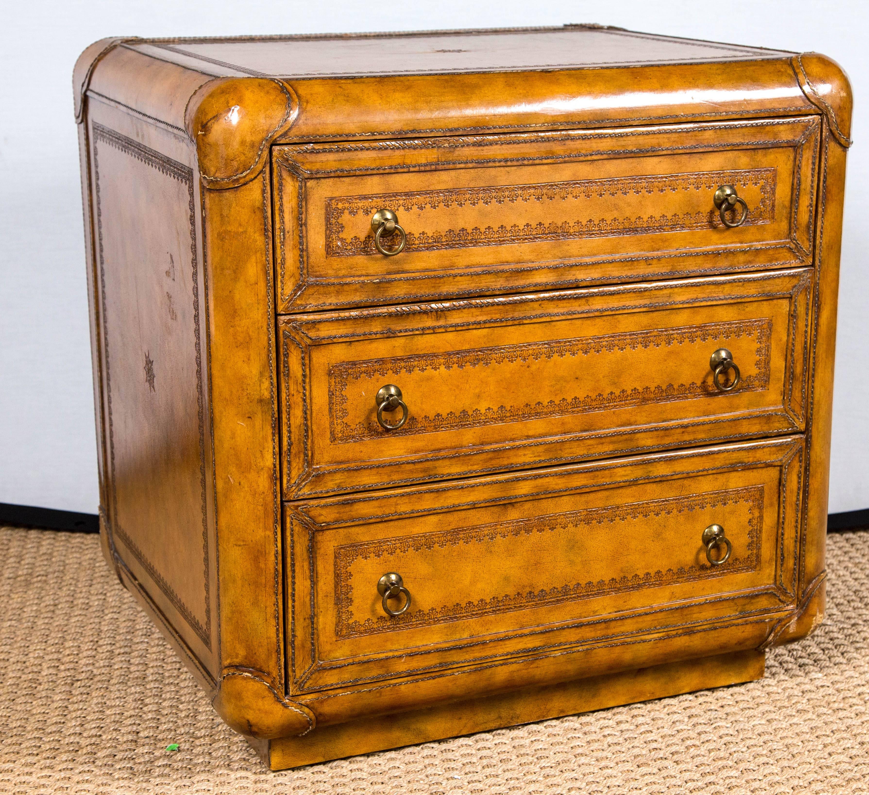 A Maitland-Smith hand tooled leather chest of drawers with three drawers. Classic with clean lines.