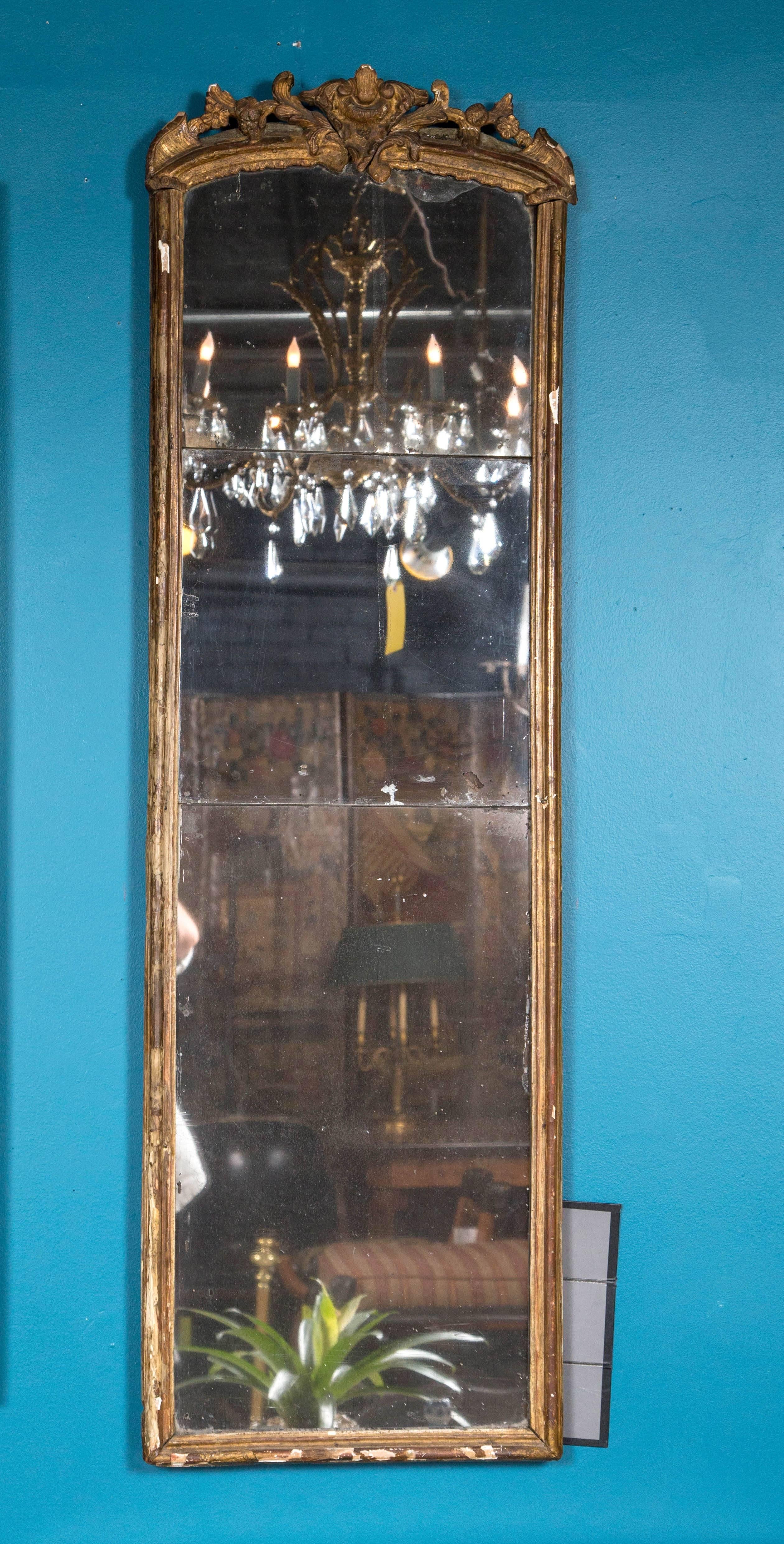 Antique three pane mirror in a gilded frame.