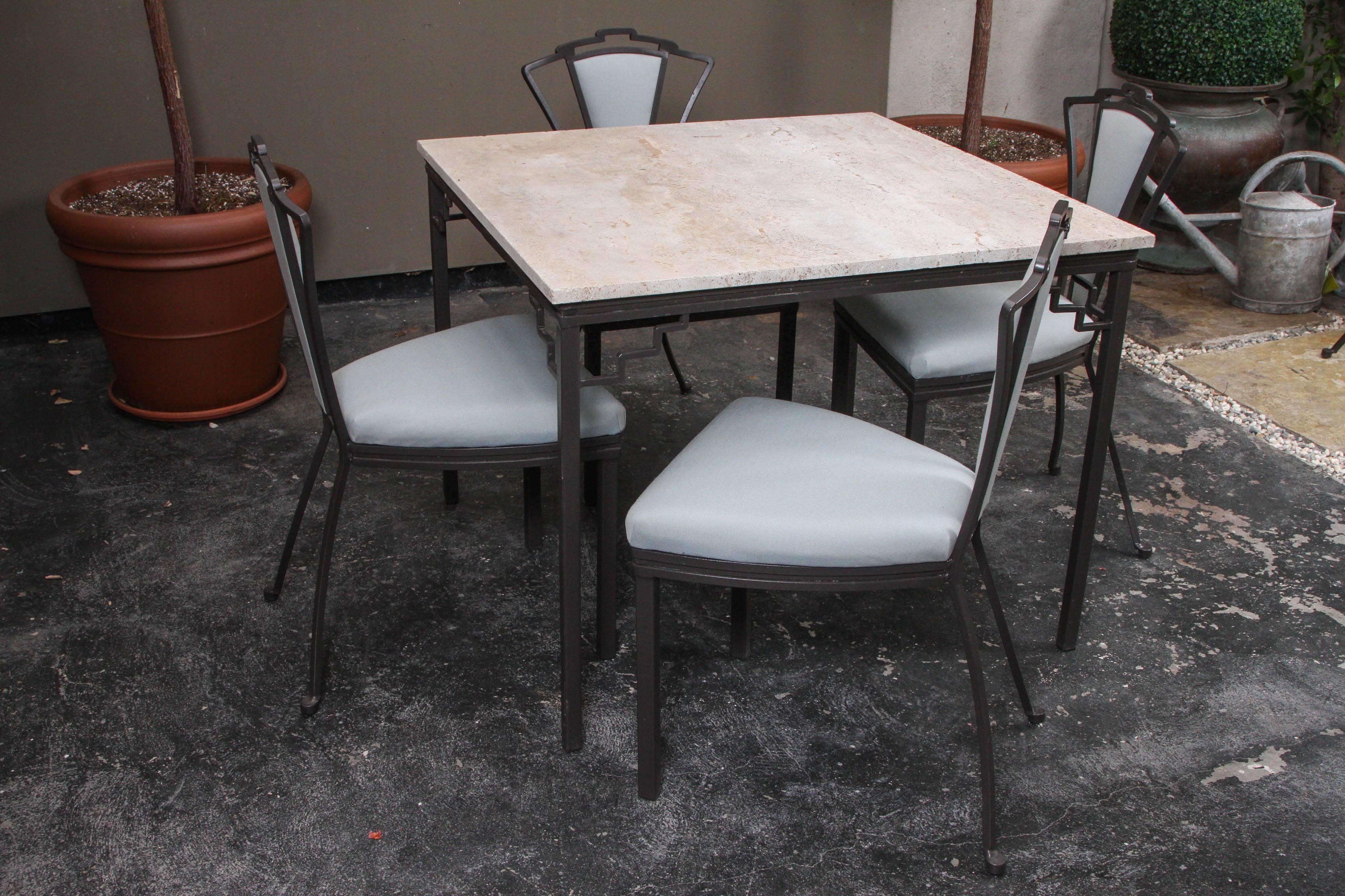 A small Art Deco-style garden set with a stone top table and six chairs. It is newly powder coated in bronze and reupholstered in Perennials fabric. The distinctive stone top is original.

Chairs measure: H 34