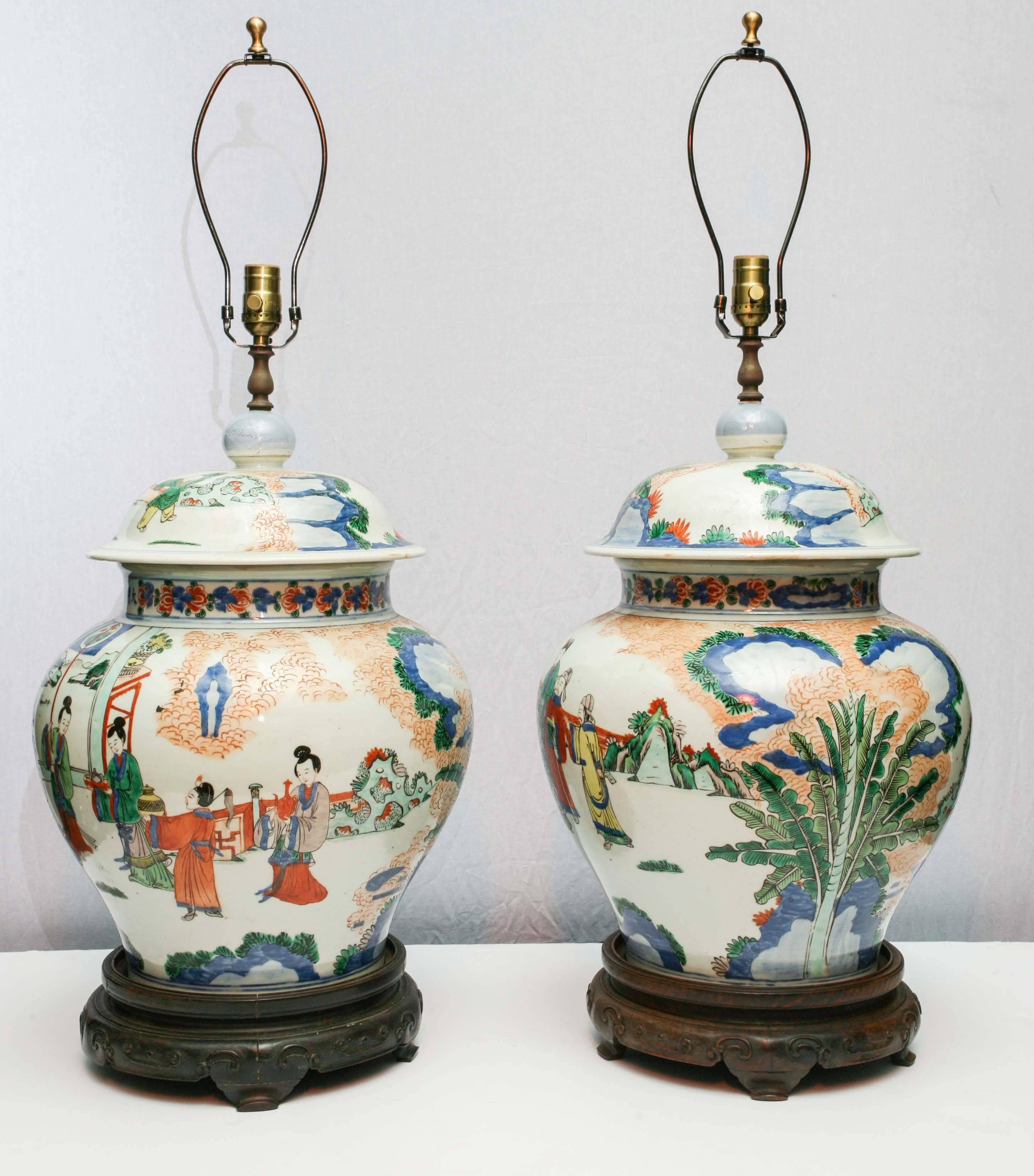 Very fine enameled pair of Chinese covered vases. 
Republic period, 
landscape and figures, banana trees, vegetal inspiration. 
Very pleasant coral orange and blue enamels.
Rescently rewired for USA.