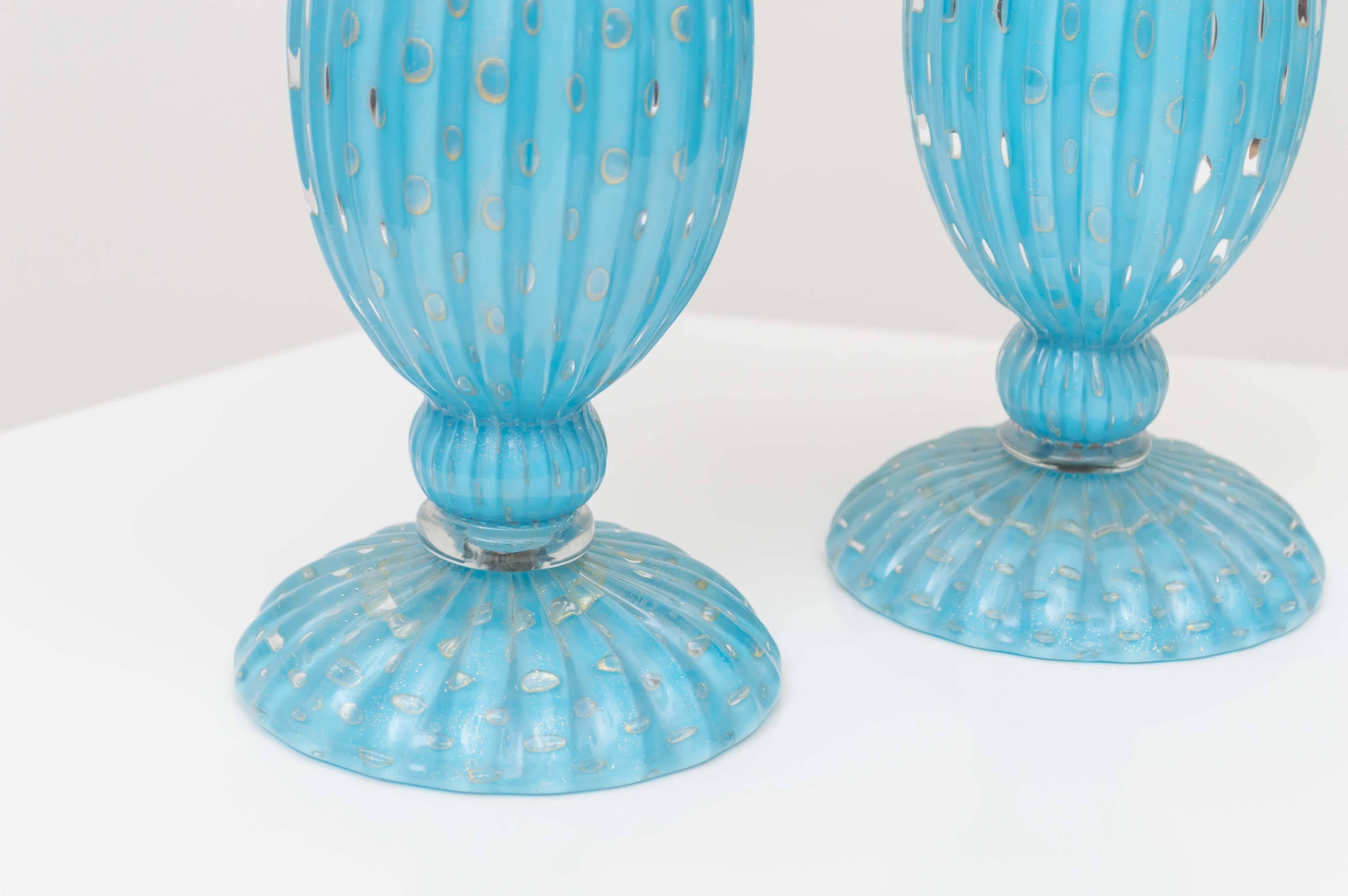 Pair of Murano handblown blue decanters. With controlled bubbles and gold flecks decanters. Documented to designer Alfredo Barbini, circa 1950s. It is profusely covered in gold leaf throughout with a ribbed body.