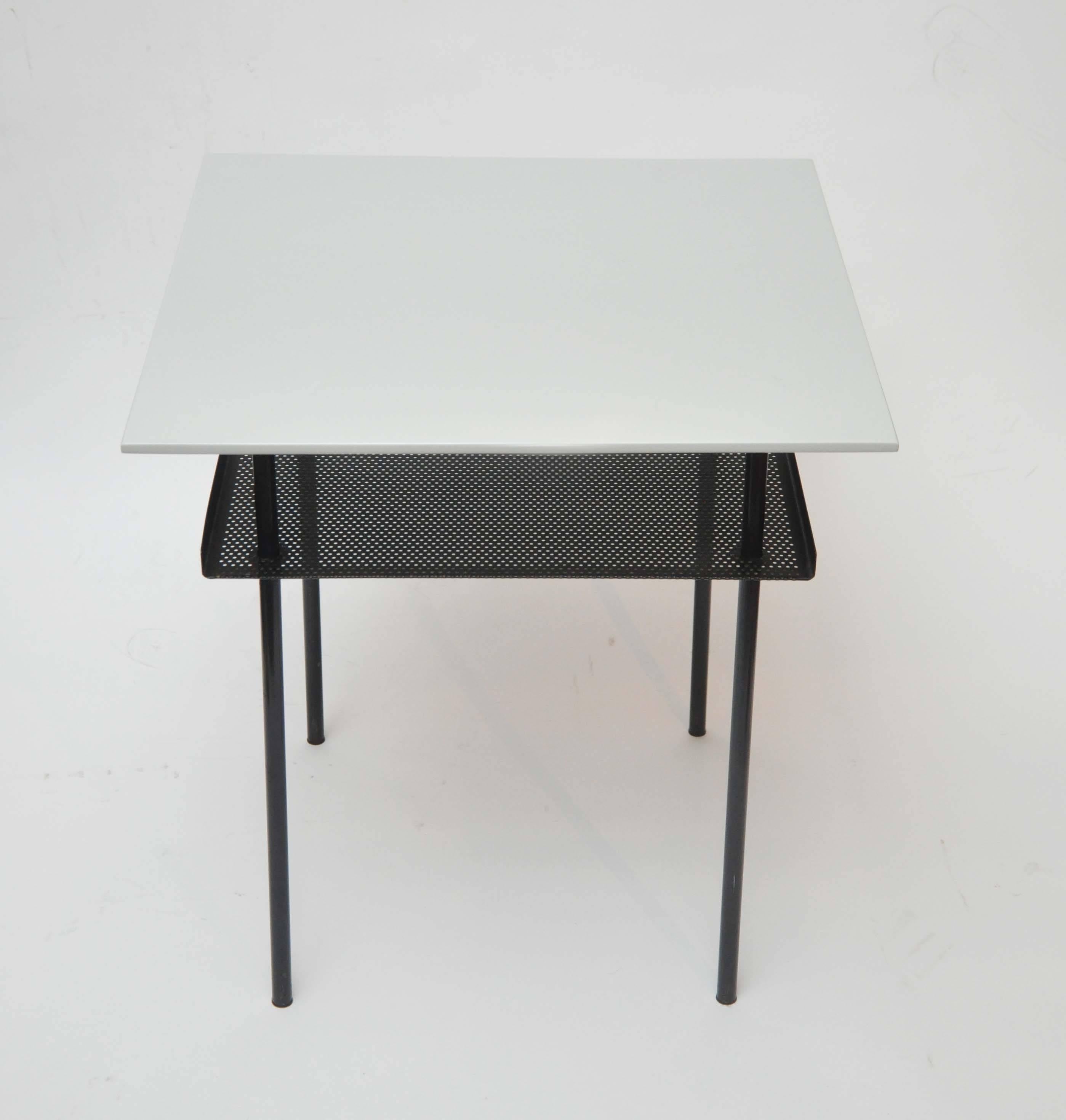 Early 20th- century Dutch designer Vim Rietveld Auping side tables from the Netherlands,circa 1950, Holland.

Two white top side tables with black metal bases features a mesh metal shelf underneath.

Dimensions: 20.5