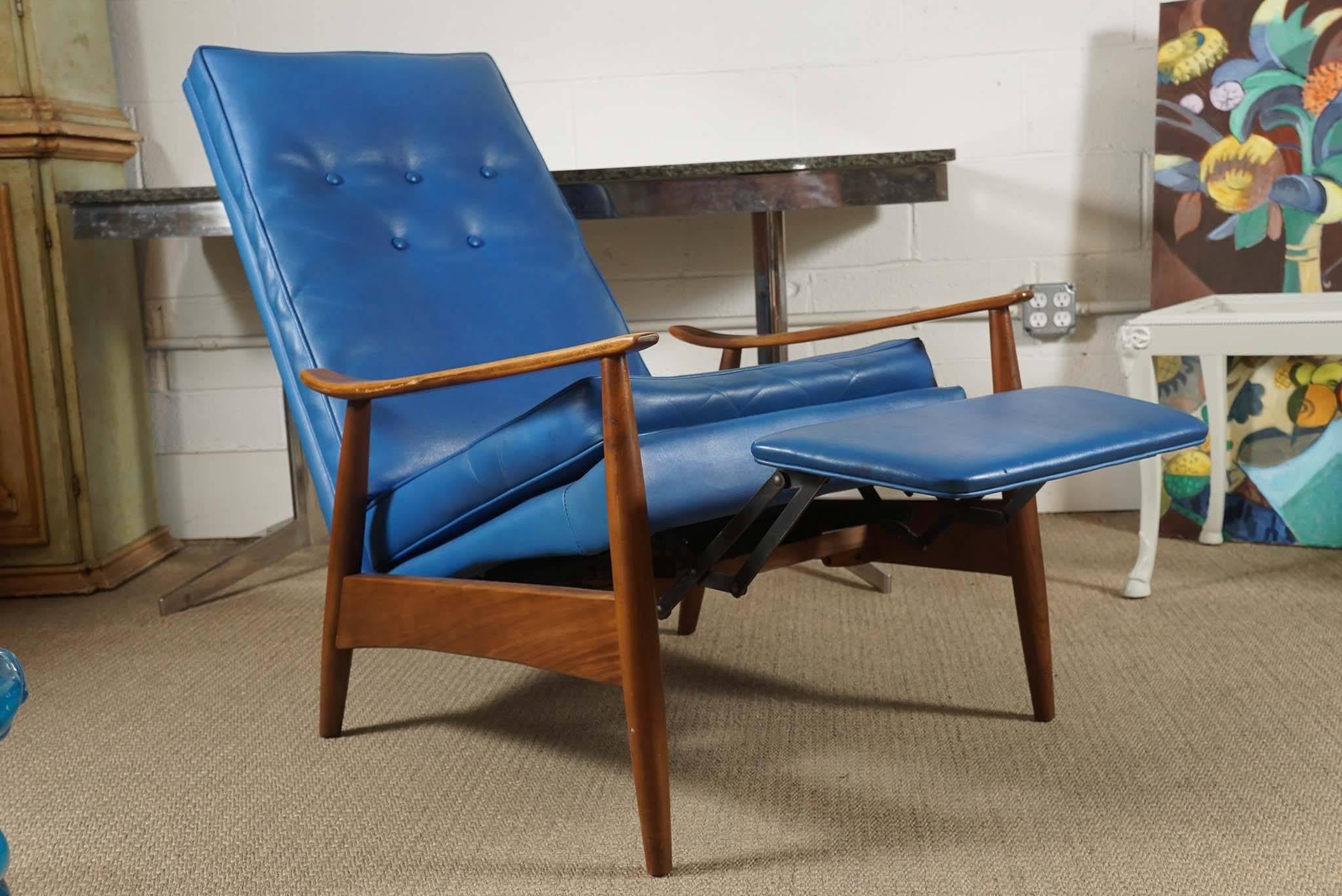 Here is a great modern armchair in a brilliant blue vinyl that also reclines.
The chair is by Milo Baughman for Thayer Coggin.