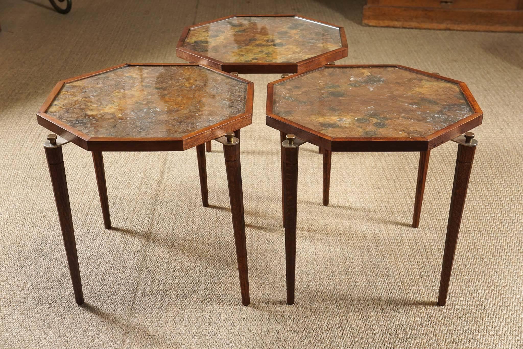 Here is a set of three walnut nesting tables with octagonal tops.
The octagonal tops are covered with a mica paper and encased in glass.
One of the tables have a loose glass inset that was replaced.
Otherwise, the pieces are in great condition.