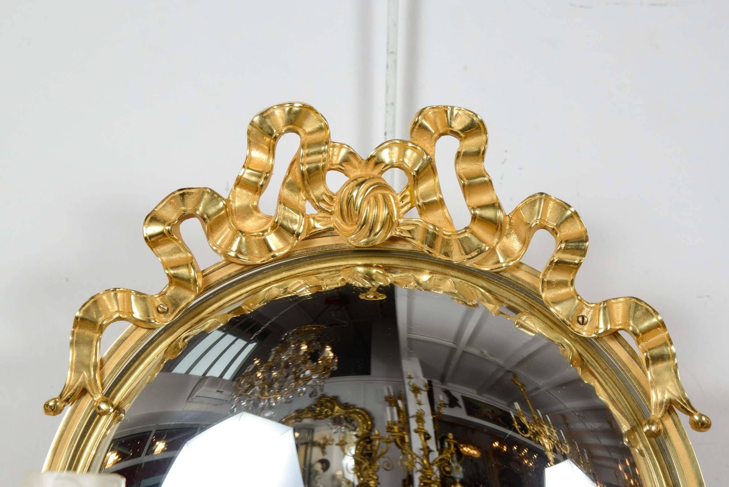 Pair of Louis XVI style gilded bronze sconces with concave mirrors.
Two lights.