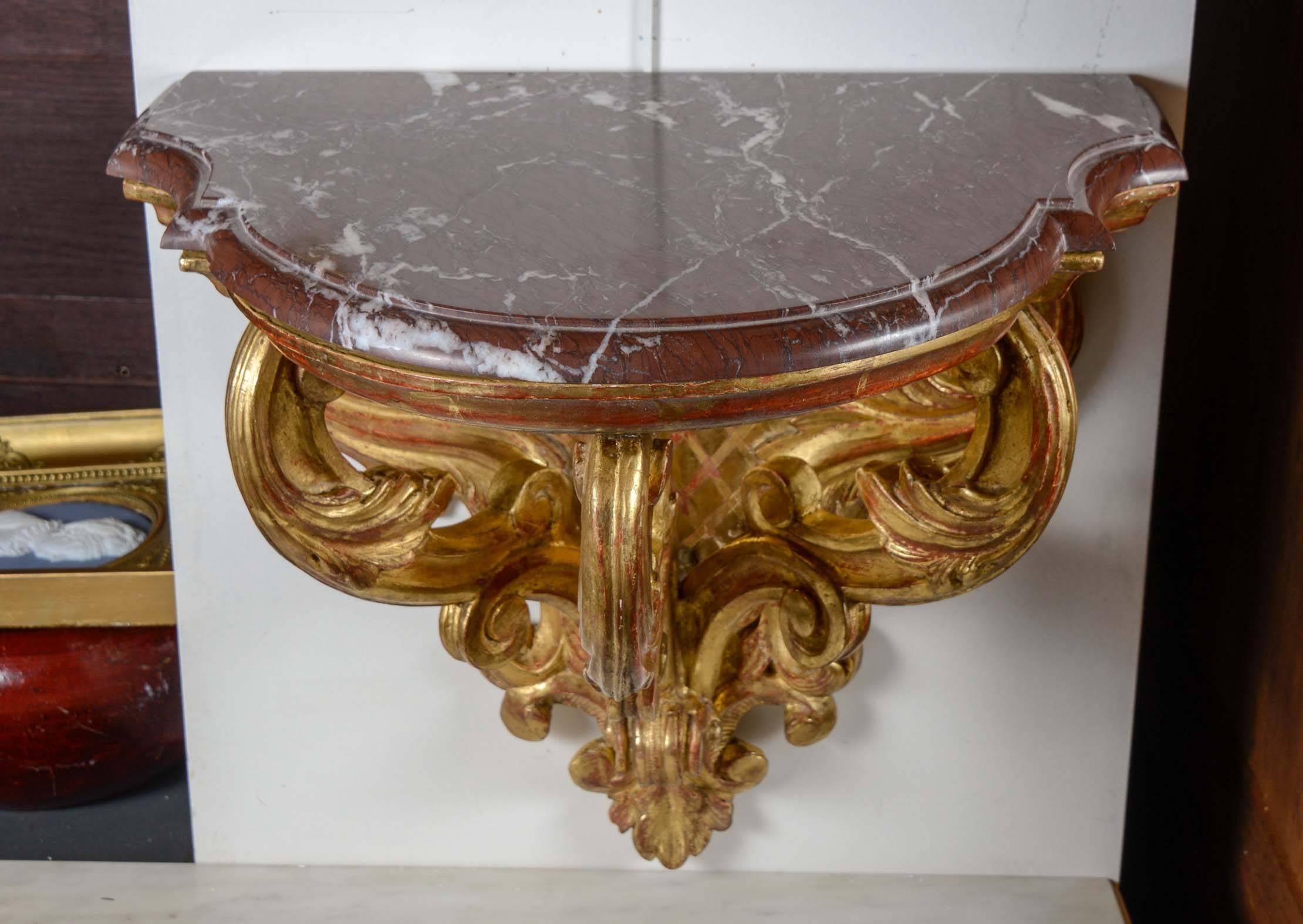 Pair of gilded wood Italian wall consoles topped by a removable marble 