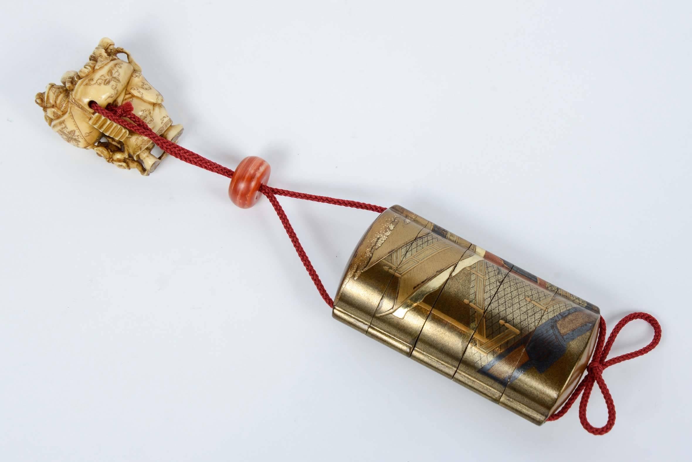 Beautiful five compartment gold lacquer Inro with polychrome decoration representing multiple characters moving towards a pavilion, a crane with wings flying over.
The interior in nashi-ji lacquer.
The ojime in coral color stone.
The netsuke is a