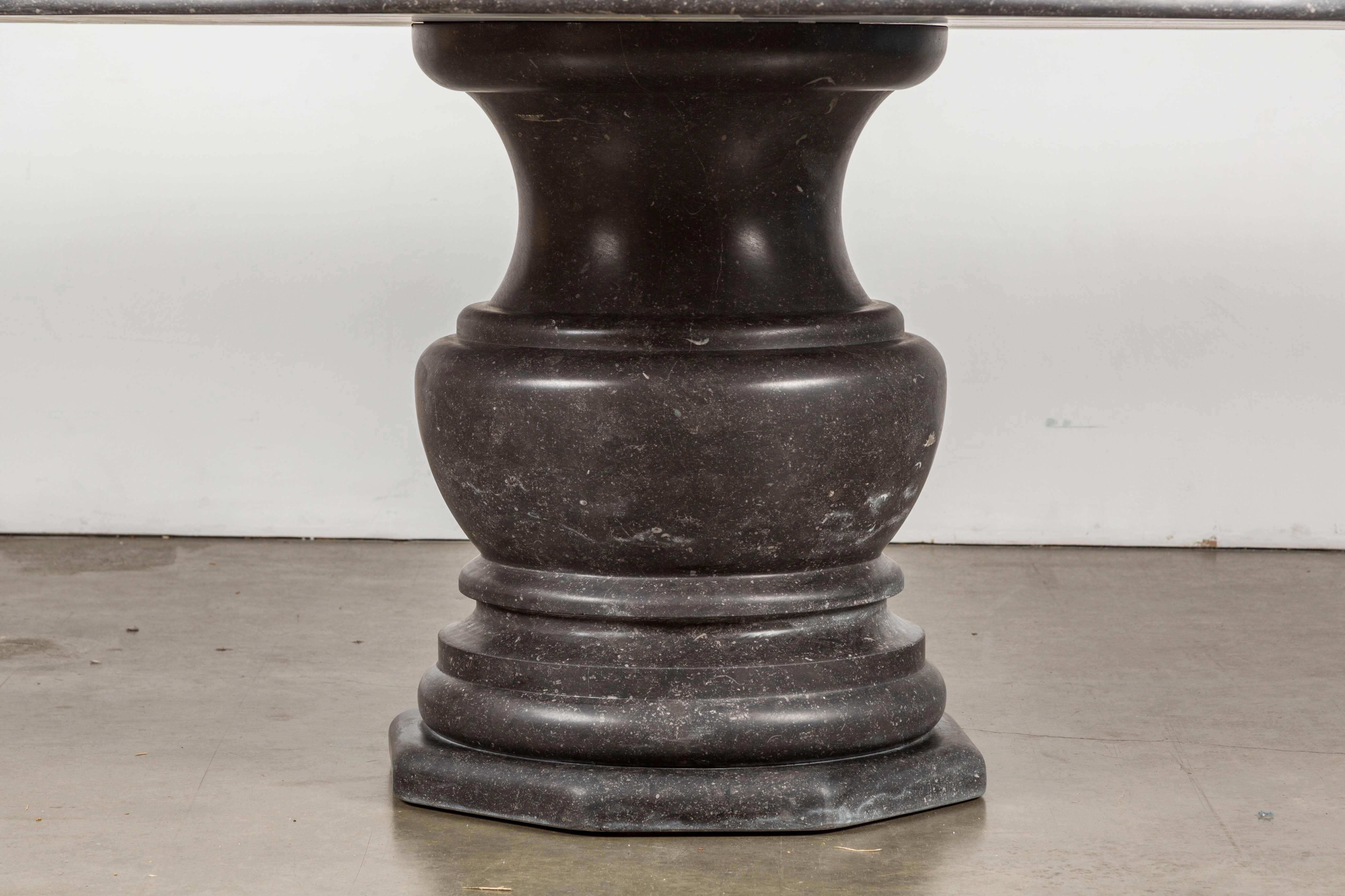 An impressive hand-carved Belgian bluestone pedestal table with a solid baluster base. Seats eight. This is an extremely heavy table; the top is ~1000 lbs and the base is ~600 lbs. Ideal for outdoor use as bluestone's low porosity makes it resistant