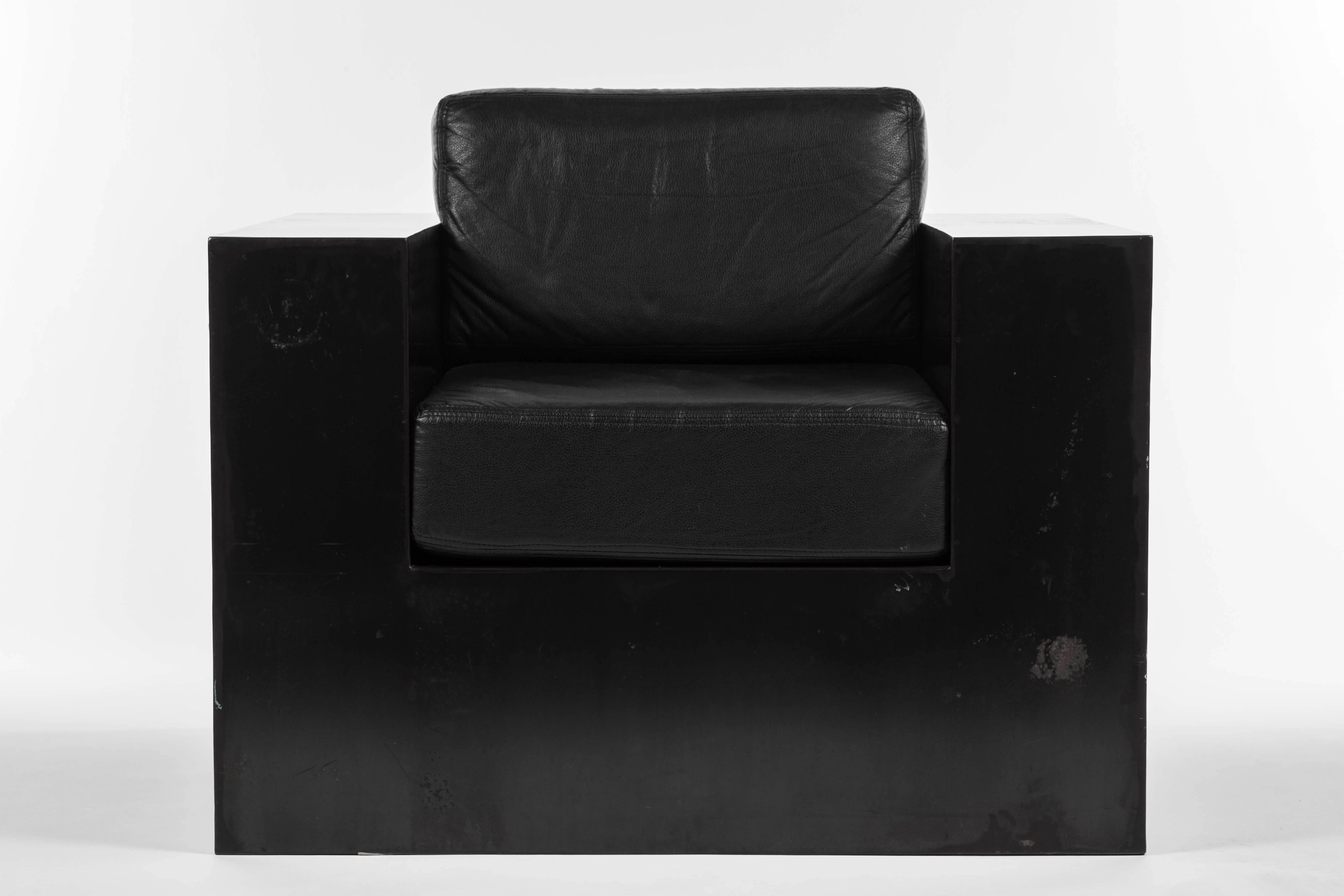 20th century Rick Owens style armchair with black iron base and black leather cushions. Some scratches and markings on the base. Height below includes top of cushion. Arm height: 25.5