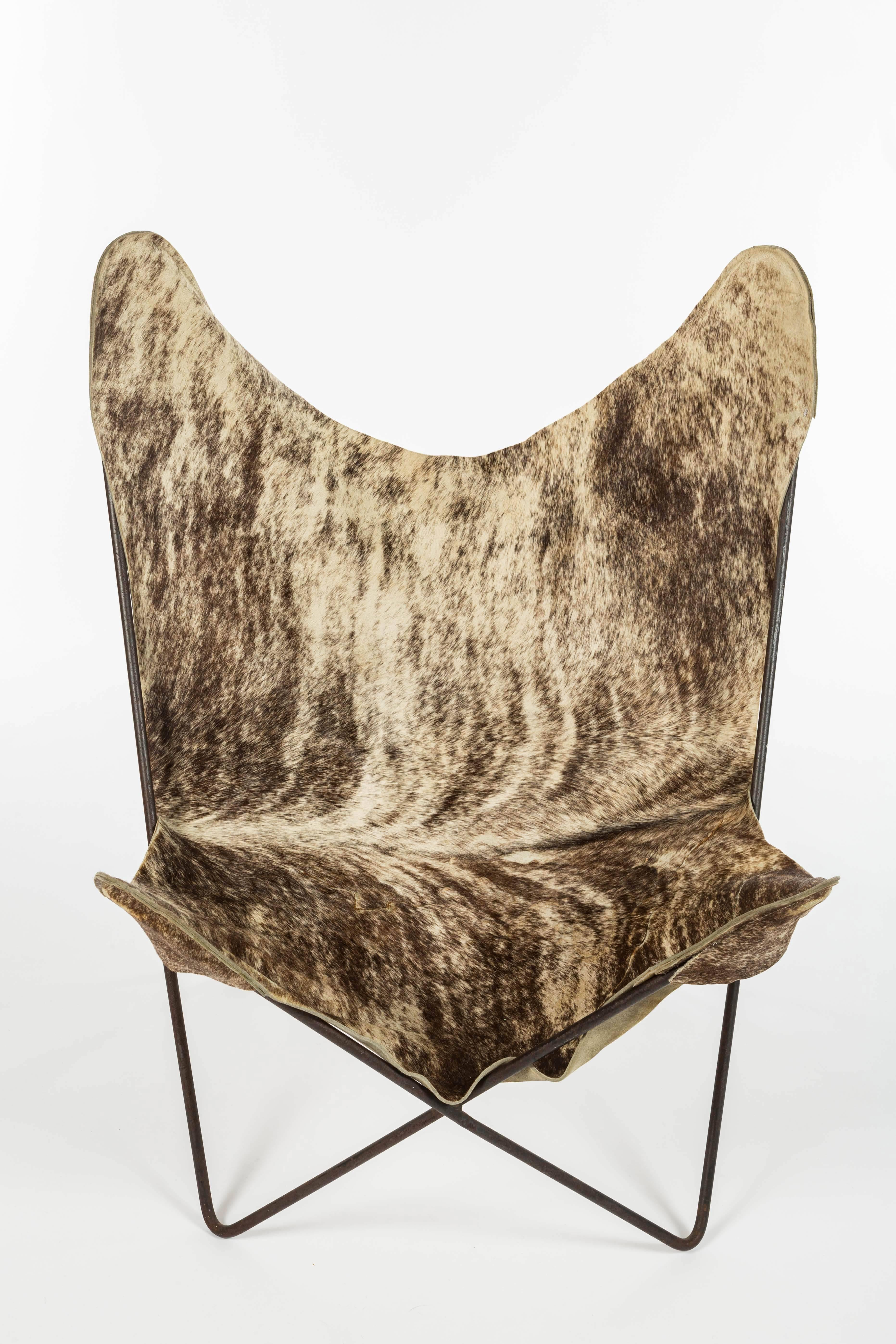 Italian c. 1960, pony hair on hide butterfly chair with iron frame. Repairs to hide on underside.