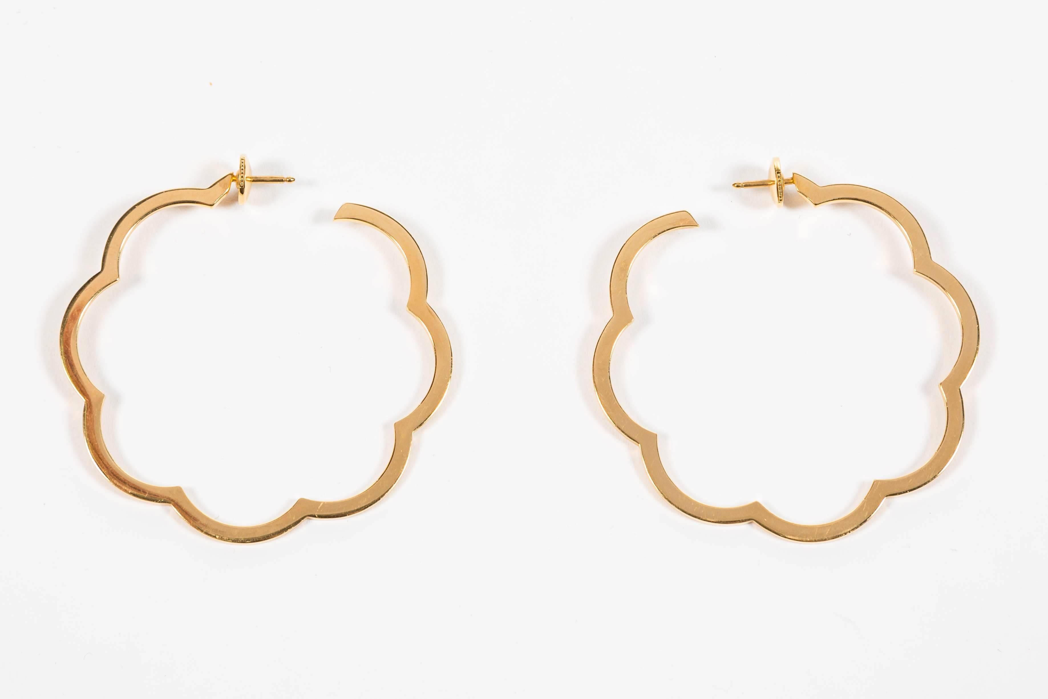 A pair of Chanel 'Camellia' hoop earrings in polished 18-karat yellow gold. Signed Chanel. Approx 2 mm thick.