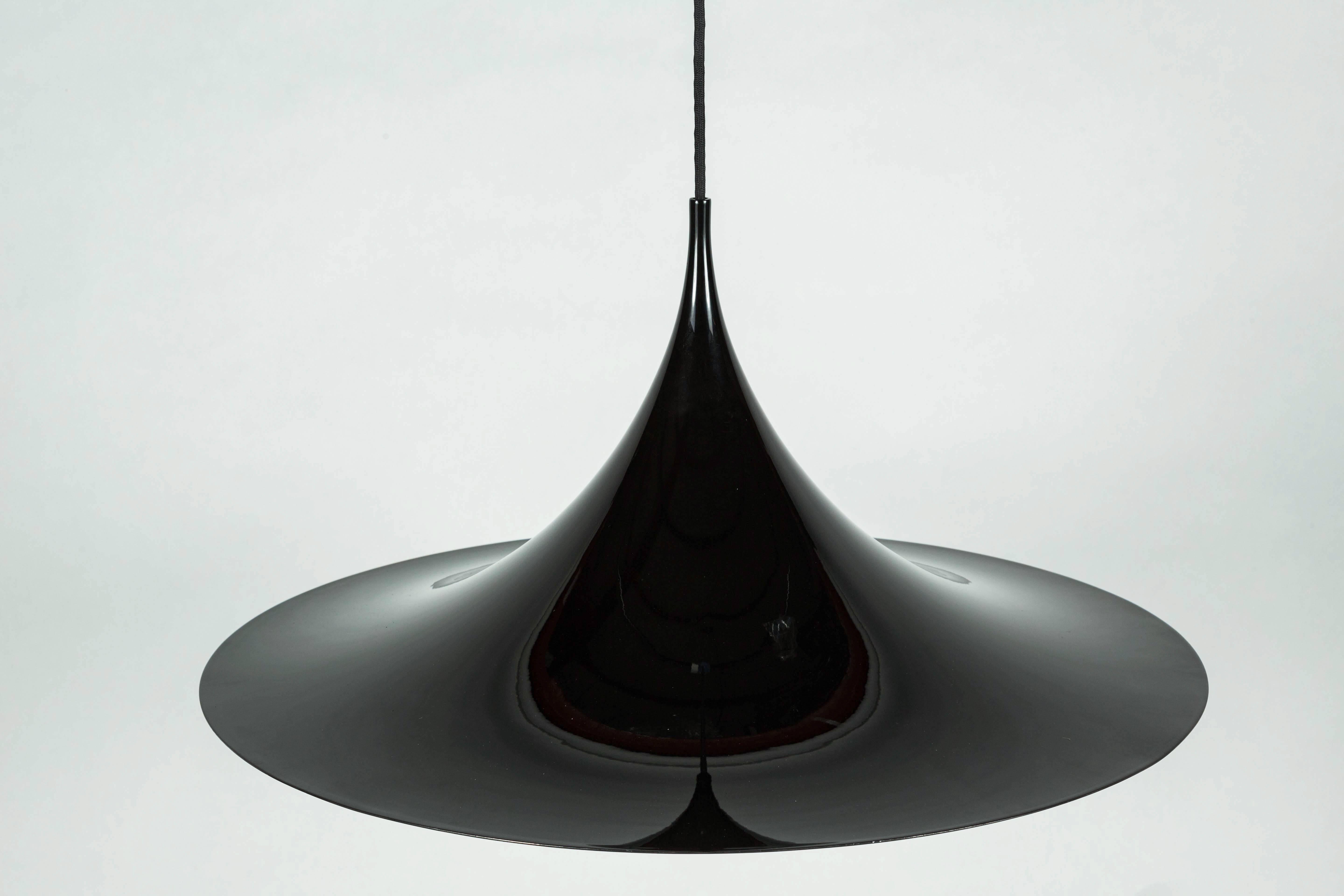 Semi pendal by Claus Bonderup and Thorston Thorp, Denmark, circa 1960.
Black metal with white enamel inner surface. 

Rewired, black cloth cord.

Produced by Fog.