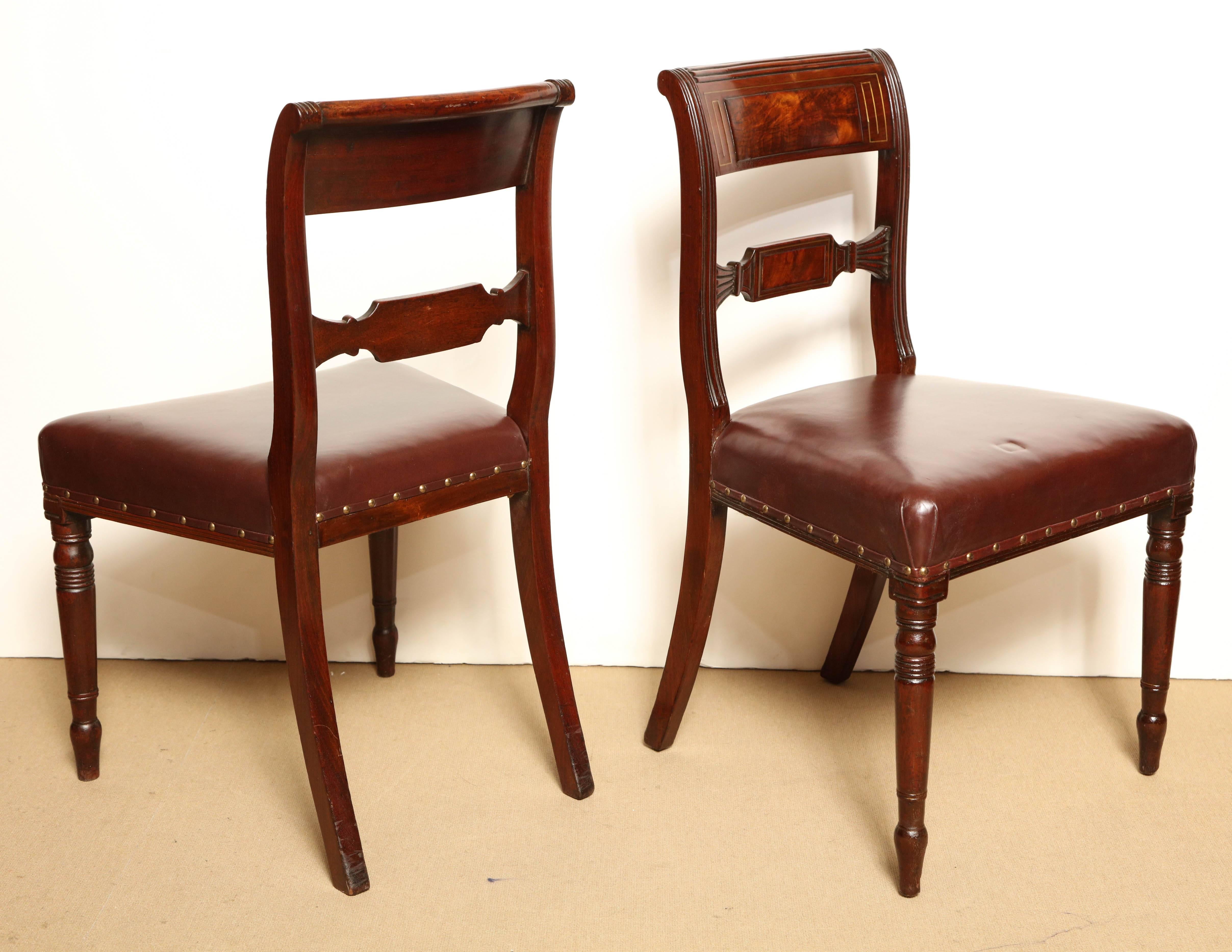 Pair of early 19th century English Regency, mahogany and brass inlay side chairs.