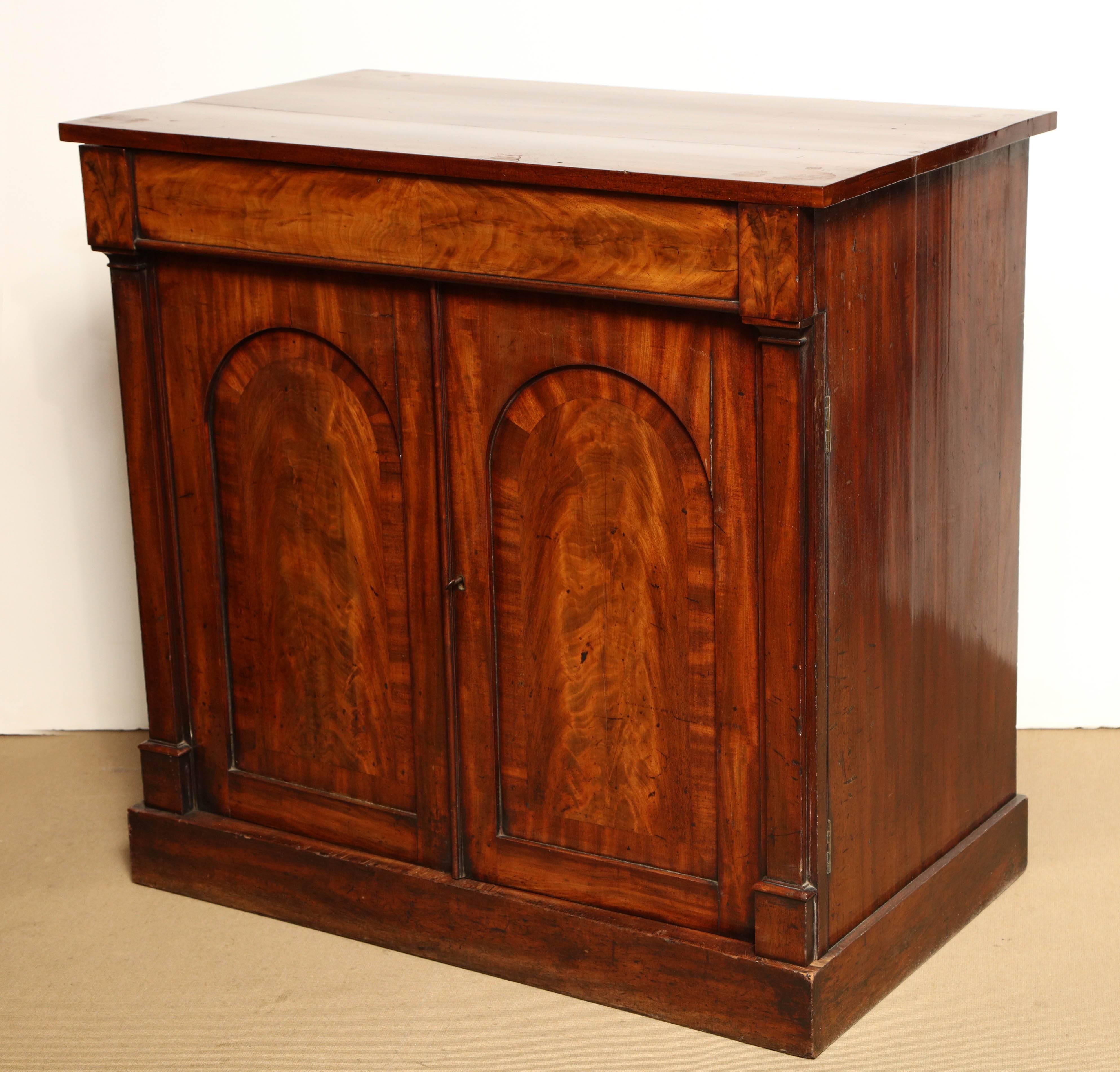 Mid-19th century English, mahogany two-door cupboard by Gillows with one drawer on top and one drawer for bottles behind the right door.
