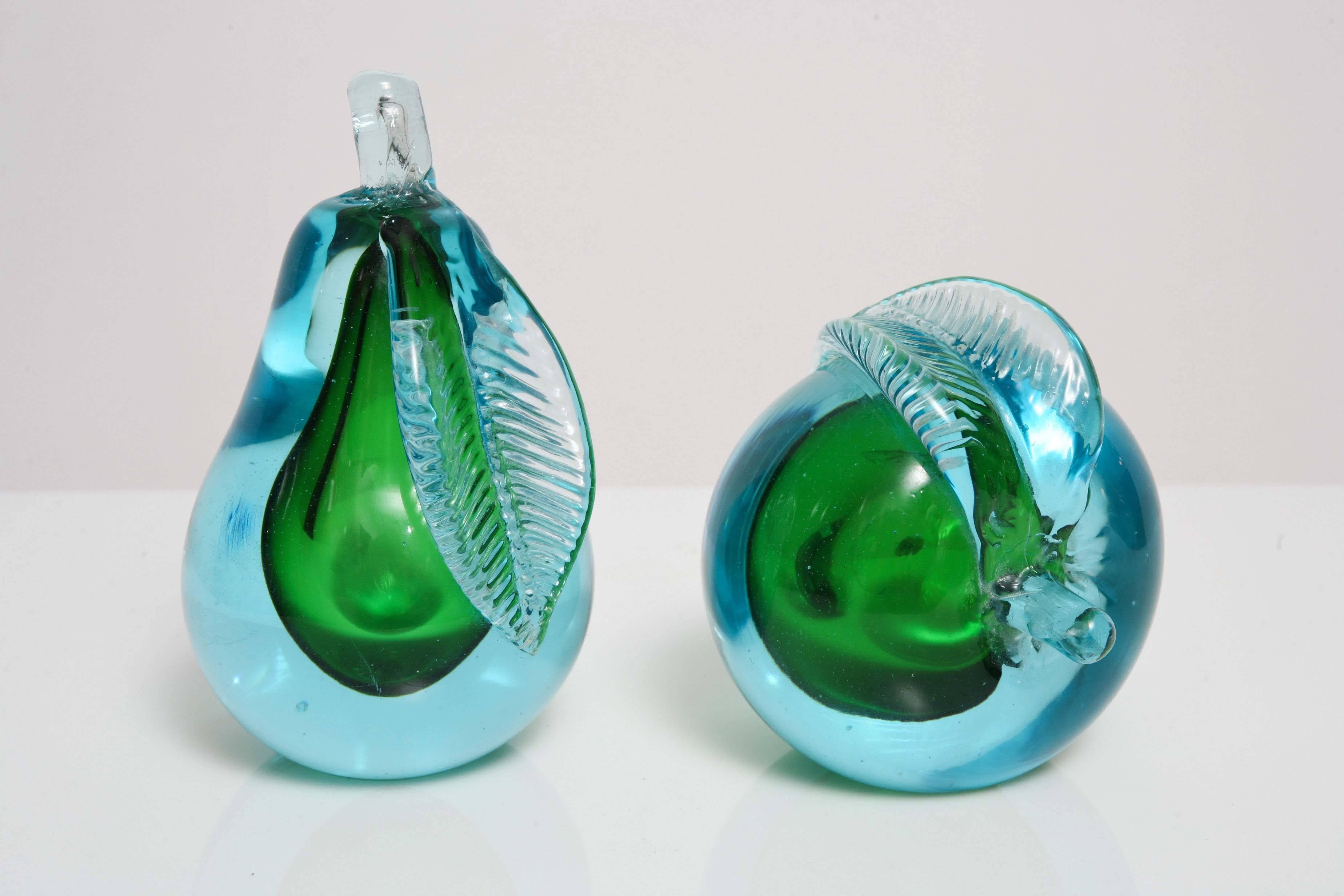 Hand blown Murano glass apple / pear bookends. Worn paper label. Colors are a light blue exterior with green interior. Striking set, could be used either as bookends or positioned in two different positions.