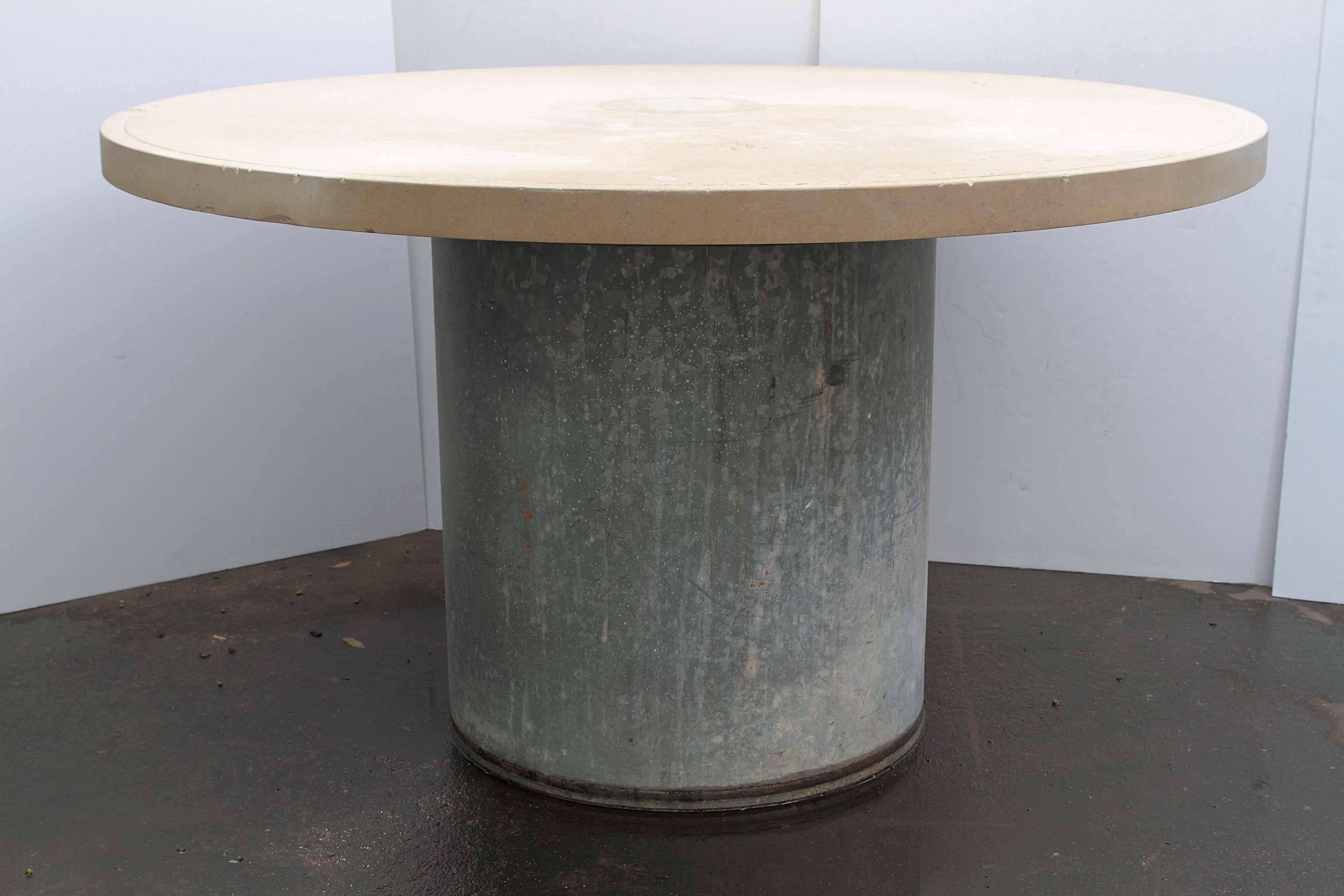 Industrial Galvanized metal and limestone garden table.
Galvanized metal used as a wine storage barrel in the 1940s in France. 
Paired with distressed limestone top with engraved circle edge.
Can be used as dining table, center table or game