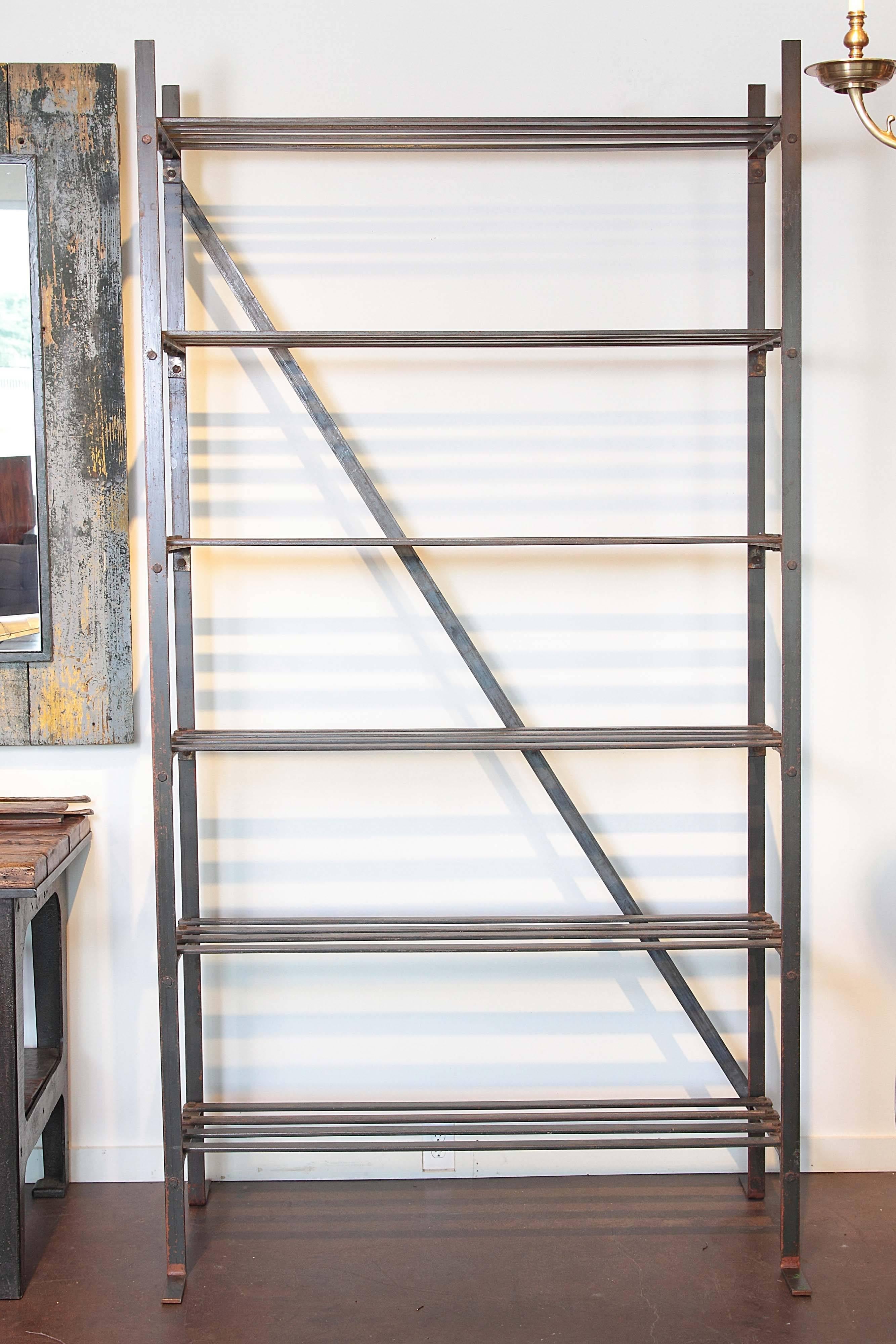 French Industrial textile etagere.
Open shelves of cast iron with industrial bolts and iron base with rust patina.

