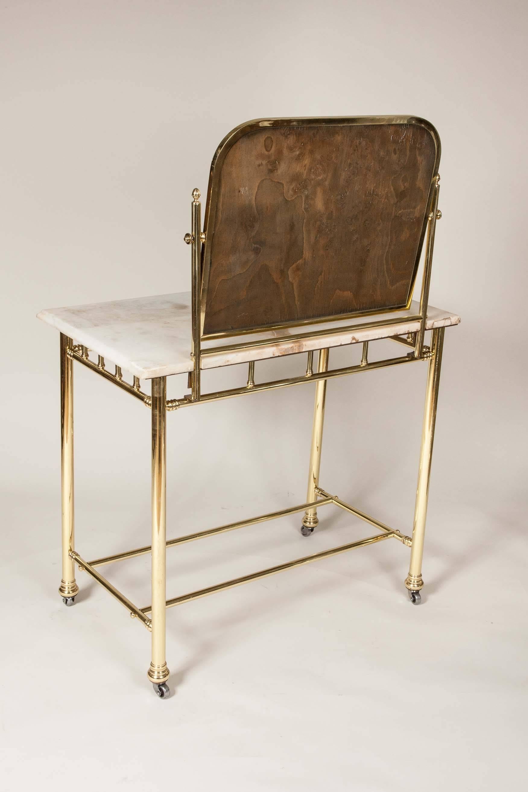 Brass An Edwardian brass dressing table with marble top, circa 1910.