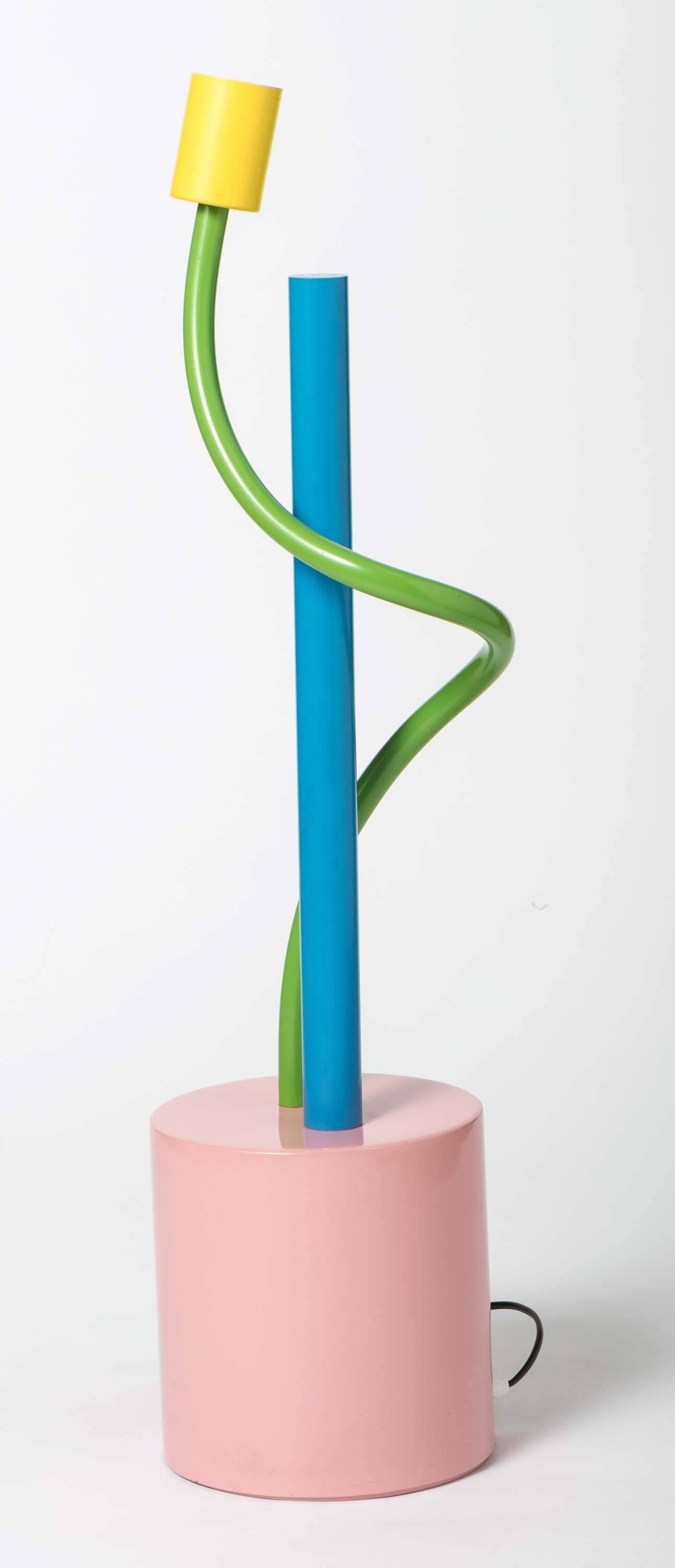 A Sinerpica lamp by Michele de Lucchi.
Painted metal.
Mark to base and numbered 278,
Italy, circa 1978.
Measures: 78 cm high x 17 cm diameter.
Lit; Alchima No. 28; 100 lights, p302
Radice “Memphis”p20.
        
