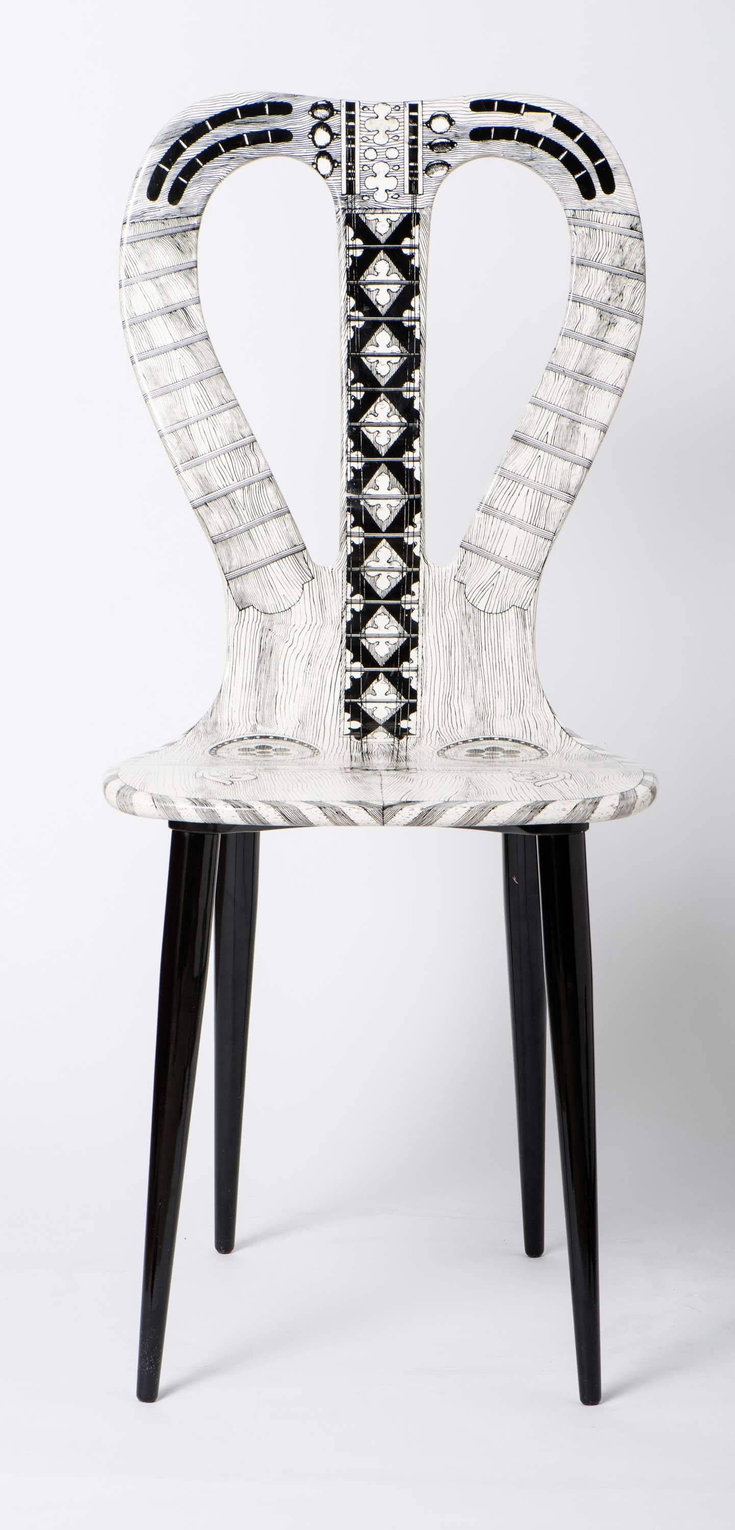 A chair by Atelier Fornasetti.
“Musicale”.
Lithographically printed.
Wood, lacquer, wooden legs.
Italy, 2006, no. 4.
 