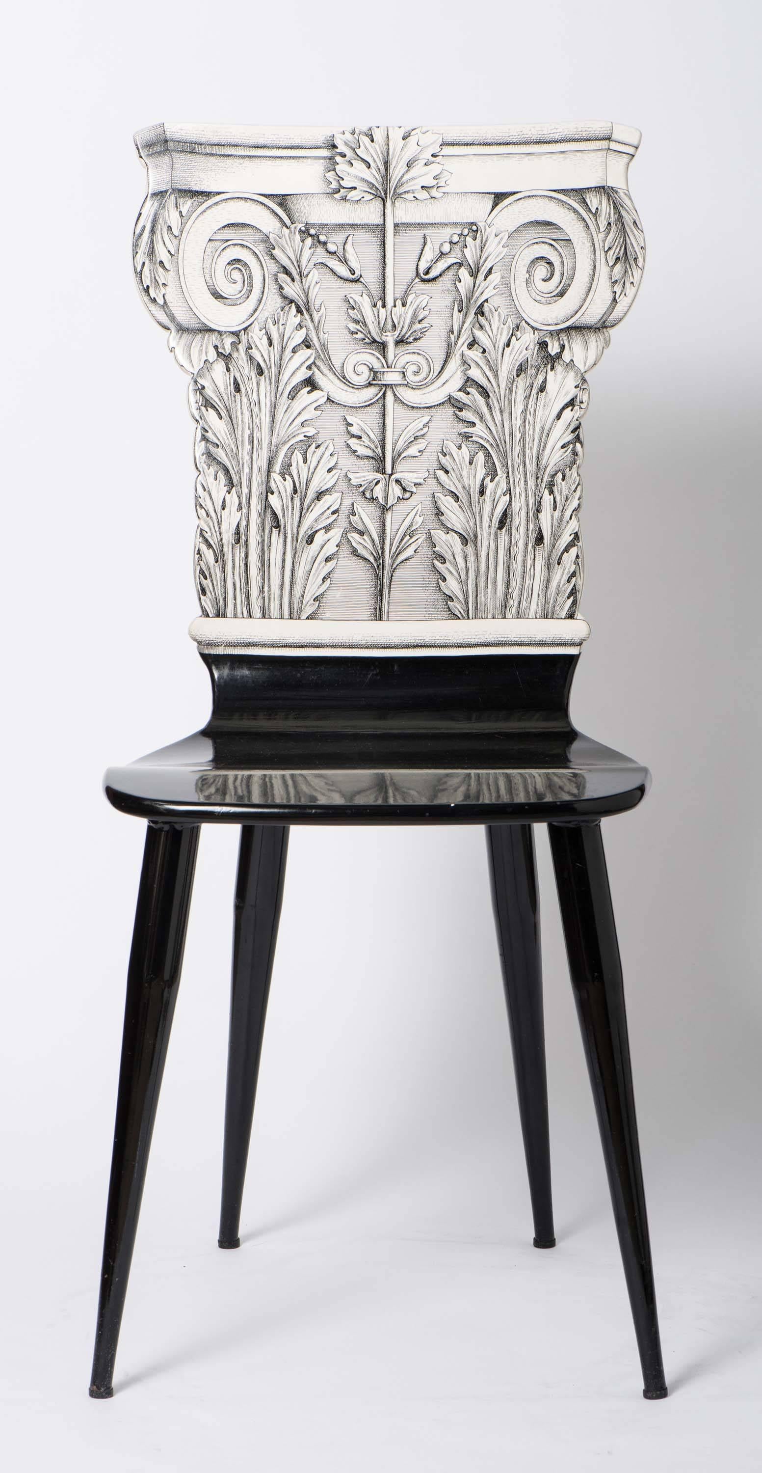 An early chair by Piero Fornasetti,
“Capitello Corinizio”
Lithographically printed.
Wood, lacquer and metal legs and base,
Italy, circa 1960.
Measures: 94 cm high x 41 cm wide x 45 cm deep.
 
