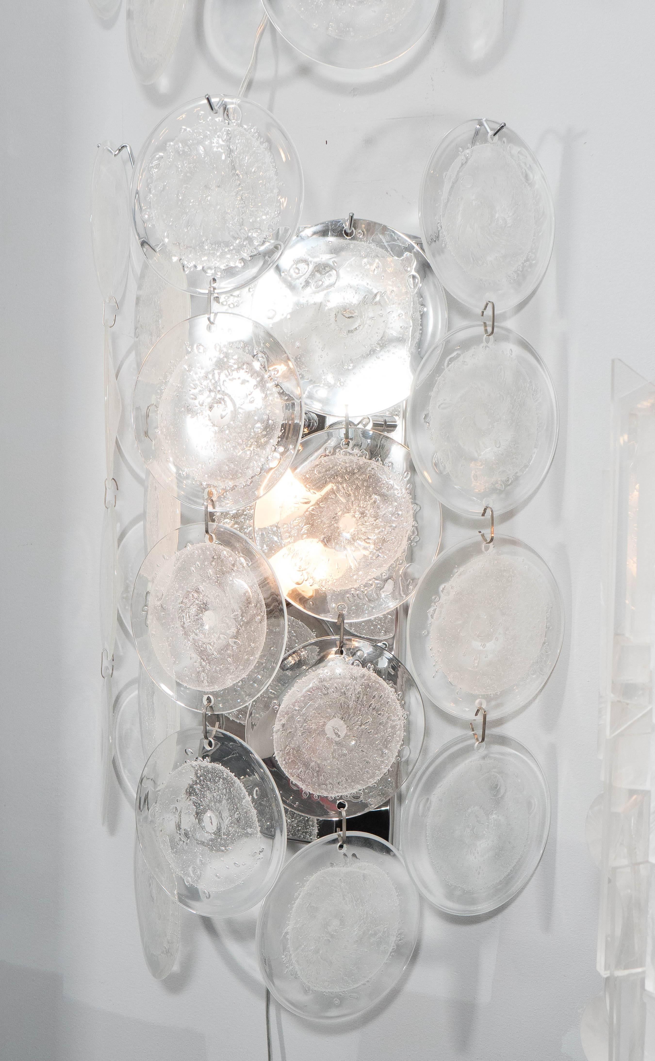 Pair of custom clear pulegoso Murano glass disc sconces, with stainless steel frame. Customization is available in different sizes, finishes and glass colors.