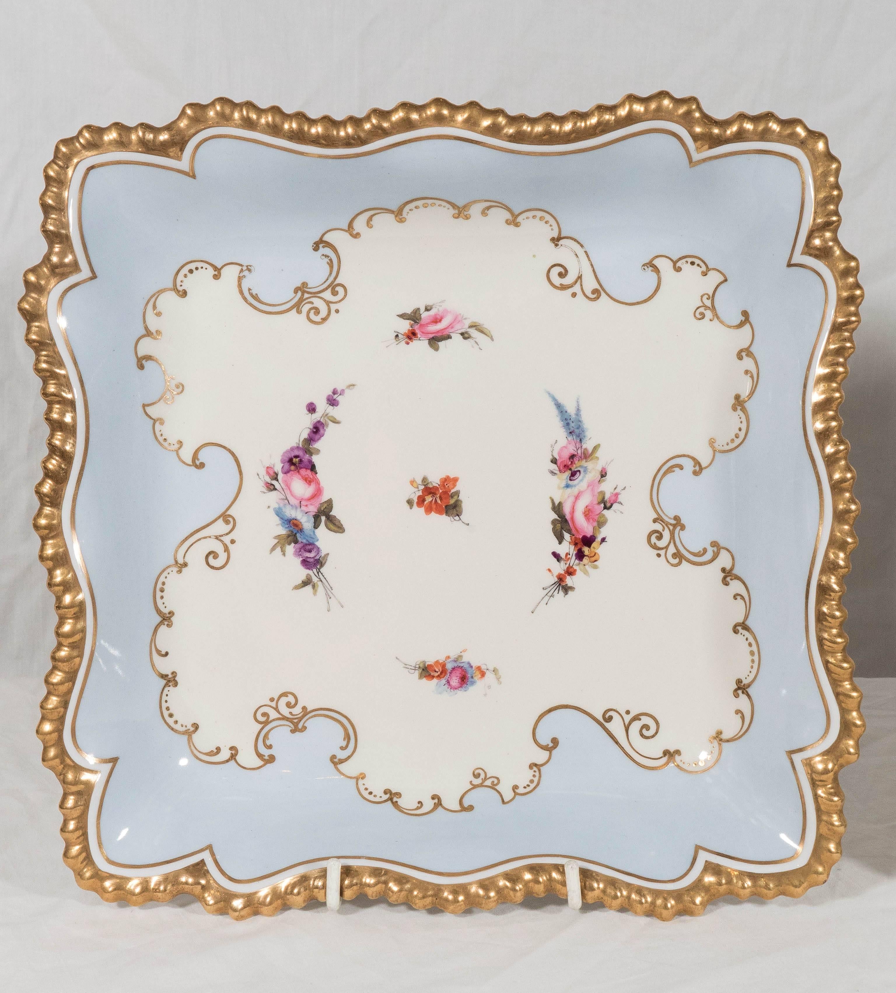 We are pleased to offer this pair of early 19th century pale blue Flight Barr Worcester square-shaped dishes with glided, gadrooned edges. In the center of each dish are hand-painted sprays of beautifully painted pink and purple flowers on a white