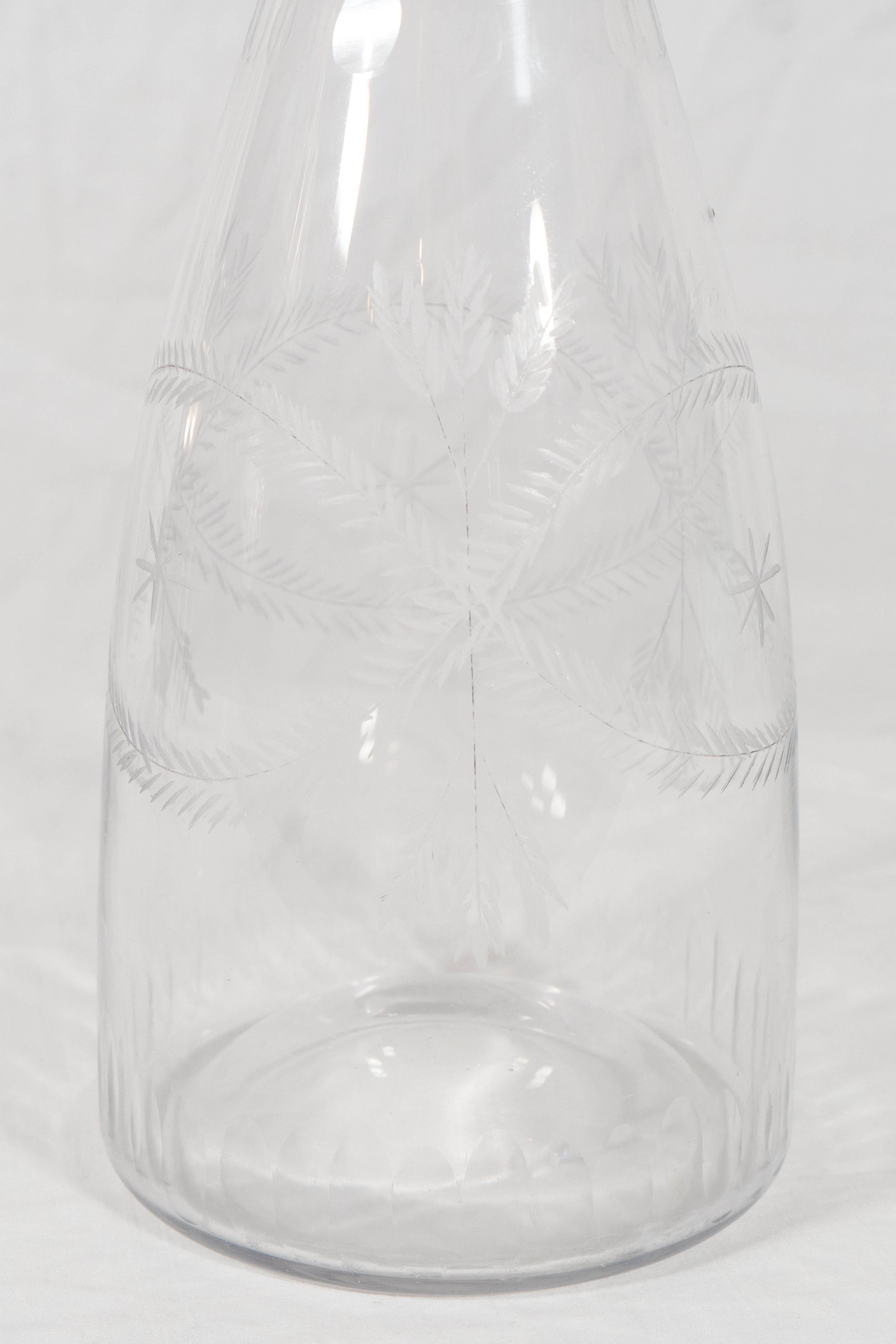 An English 18th century whisky decanter engraved with stars and wheat sheaves (whisky is made of fermented wheat). The base and the neck with flat cut ovals all around. The style of engraving and the flat cut stopper date the bottle to the last
