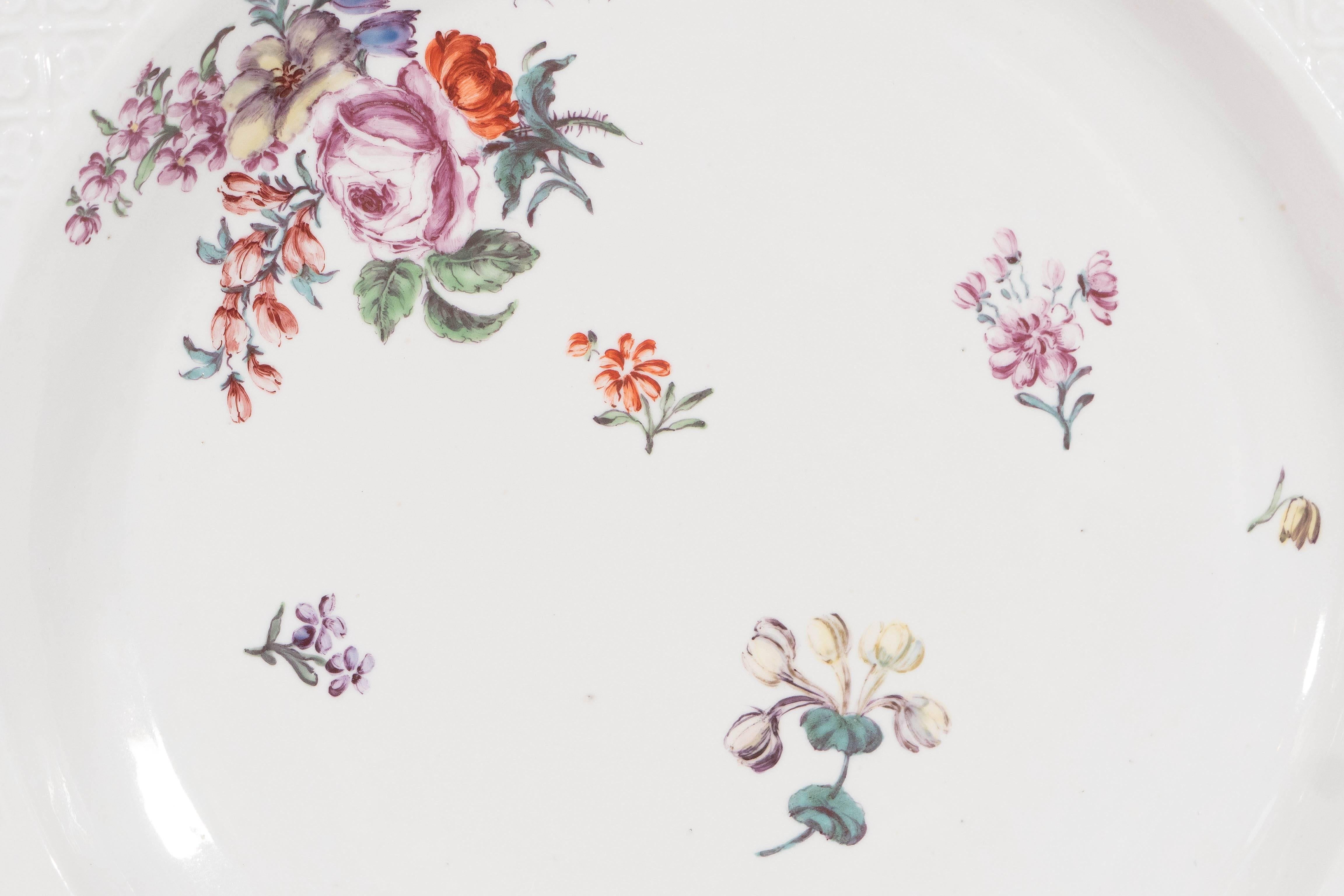 A Chelsea octagonal dish made in the red anchor period (1752-1756). Inspired by the original Meissen porcelains early Chelsea tableware decorated with European flowers and insects was popular from the late 1740s until, circa 1758. This octagonal
