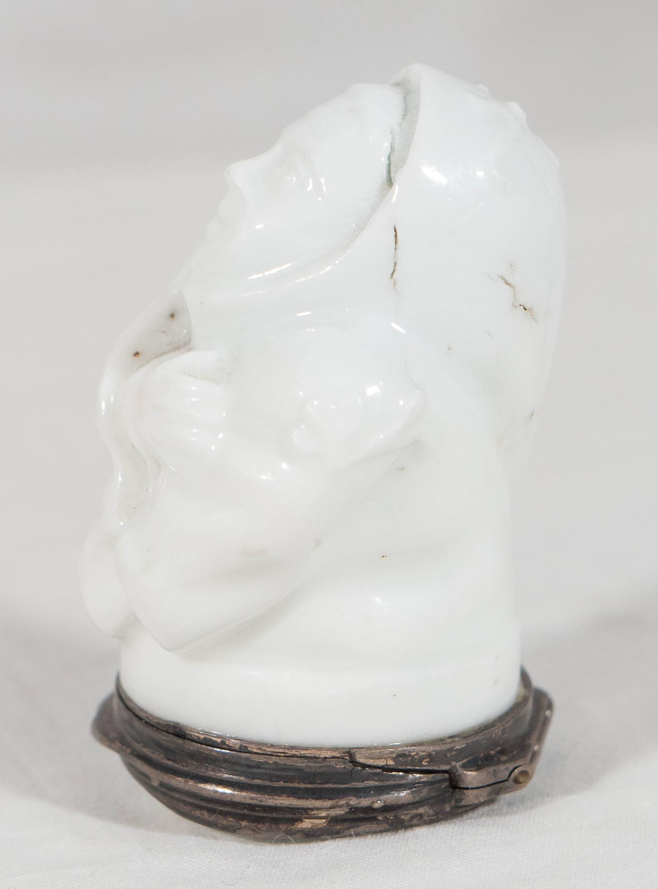 A rare 18th century porcelain snuff box naturalistically modeled as a friar wrapped in a hooded robe with only his face and hands exposed. The base is decorated with a single flower.
The Mennecy Porcelain Manufactory was one of the first French