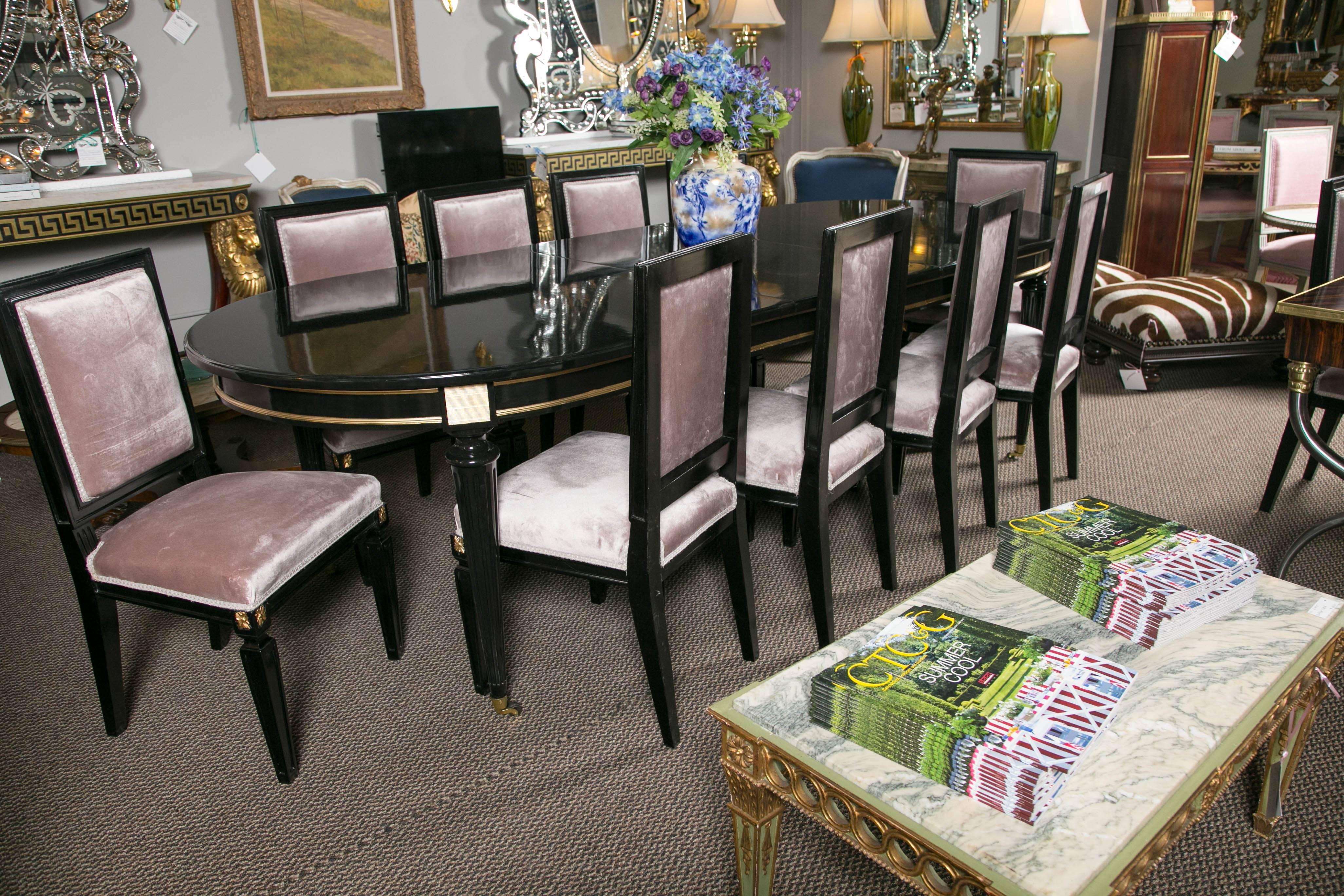 A set of recently upholstered dining chairs in the style of Maison Jansen. This set shows Hollywood Regency at its finest. No details were left undone in making this one of a kind set of ebonized chairs. 12 in all, you may purchase as many as you